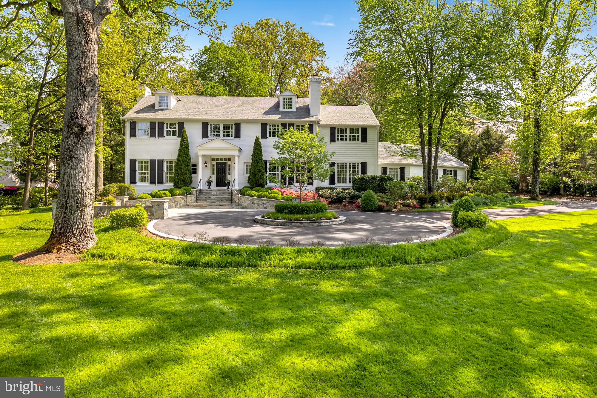Fabulous home on one of the most sought after streets in Bethesda! This stunning white brick colonial is beautifully renovated and includes a gorgeous kitchen overlooking the lush level backyard. The main level offers a spectacular open plan with ten foot ceilings, separate wood paneled office, and is flooded with light on all sides though oversized UV protected Pella windows. The spacious mudroom includes two large closets, built-in desk area with window, and plentiful cubbies with hooks. Three sets of french doors open to the expansive slate patio with multiple sitting areas and decorative trellis. The flow inside and out of this house is great for entertaining. The owners suite includes a sitting room and an impressive walk-in closet. The spa bathroom includes freestanding tub, separate vanities, and marble floors and marble shower with rain-head. All upstairs bedrooms connect to luxurious ensuite bathrooms. The attic is accessible by a nicely finished staircase and could easily be converted into an additional bedroom, office, and/or playroom. The lower level includes a sunlit recreation room, 5th bedroom, full bathroom, spacious play space, plenty of storage and has a walk-up to the backyard. The recently repaved circular driveway allows for easy access in and out of the property and is great for bikes and scooters. The rear parking area accesses the two car garage while doubling as a basketball or sports court. Includes three fireplaces with gas logs, 20kw natural gas generator, security system, and three zone HVAC. Bradley Blvd offers convenient access to downtown Bethesda and Potomac while avoiding River Road backups. See floor plans in photo tour.