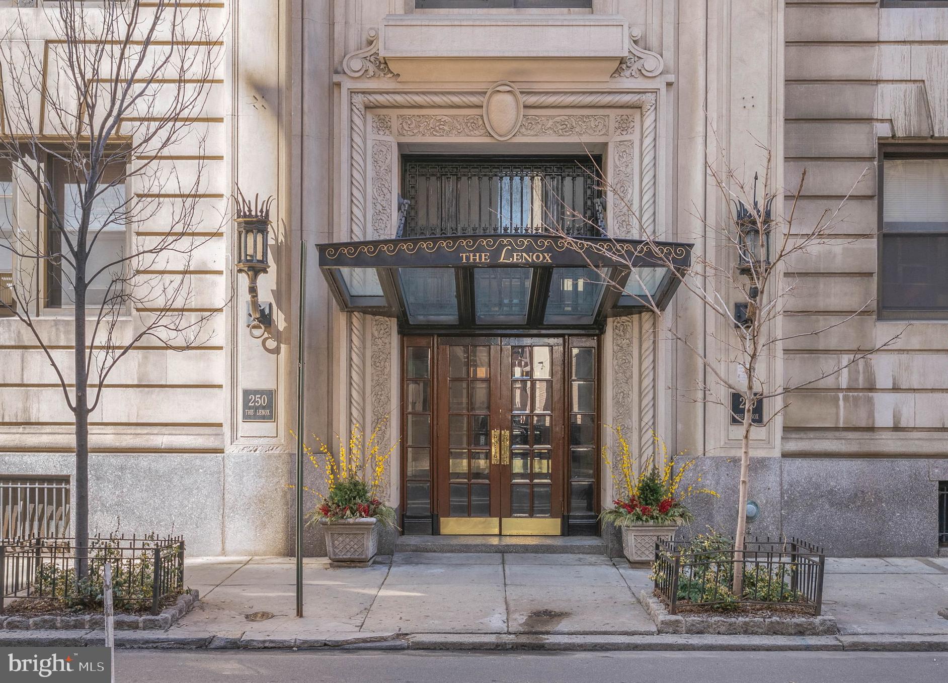 A prized parking spot and a prime location make 250 S 13th St #12E a standout choice for a
buyer seeking the best of city living. Located in The Lenox, a historic and meticulously
maintained property just off Broad Street in Washington Square West, this 1 bed, 1 bath corner
unit boasts a luxuriously renovated kitchen, mini-split A/C, and mesmerizing skyline views in
addition to the building’s welcome desk, prompt elevator service, laundry room, and relaxing
roof deck. Stepping through the grand double doors, you’re greeted by an elegant lobby
swathed in rich wood, gleaming marble, and ornate millwork. Inside the unit, a spacious foyer
offers two organized closets and room for a bench. Intricate hardwood floors stretch into the
bright, airy living room and open kitchen. Soaring ceilings frame the space, while bay windows
provide lots of natural light and a carved fireplace mantel acts as an anchor. The layout easily
accommodates separate areas for relaxing and dining. The show-stopping all-white kitchen is
fitted with generous custom shaker cabinetry, quartz waterfall counters that rise into the
backsplash, and a mix of high-end stainless steel and hidden panel appliances. On the
opposite wing of the home are the updated full bathroom and the large bedroom, complete
with tall windows and a walk-in closet.  In addition to everything inside, The Lenox sits at the
intersection of Washington Sq W, Center City, and Rittenhouse, earning a near-perfect Walk
Score of 98 and is dog and cat friendly! Lively entertainment at The Kimmel Center, the city’s best shopping along Walnut St, and award-winning dining on 13th St are all steps away. Sprawling parks are close, plus there’s easy access to Pennsylvania & Jefferson Hospitals, City Hall, public transit, the
Parkway, and I-676. Schedule your tour today! New elevators to be installed in 2027! Some photos are AI enhanced.