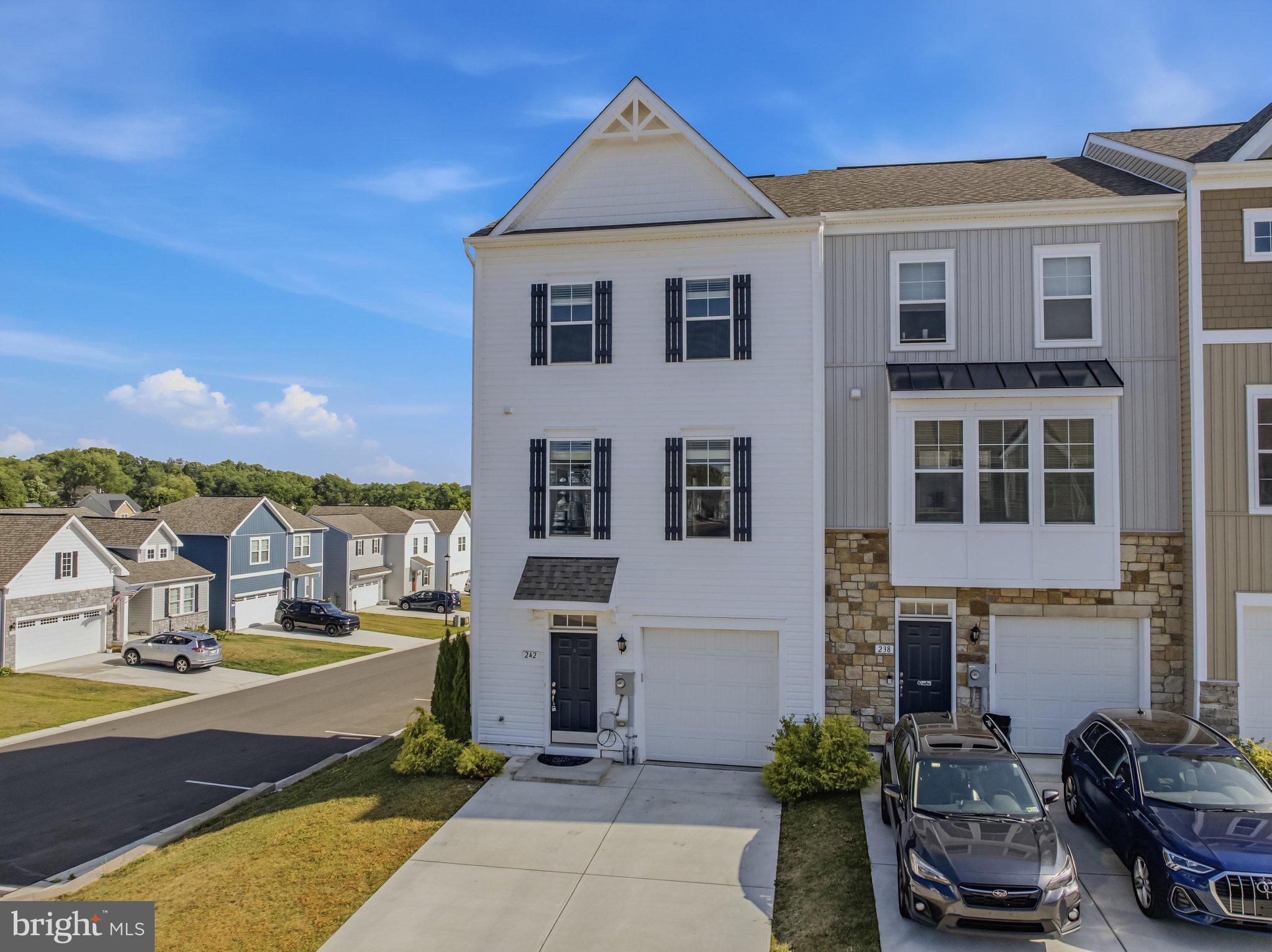Why wait for new construction when you can move right into this beautifully upgraded end-unit townhome in Overlook at Riverside? Built with over $75,000 in builder upgrades, this Darlington II floor plan offers a premium rear morning room extension on every level, adding valuable space and natural light throughout. The open main level features luxury vinyl plank flooring, boxed oak stairs, recessed lighting, and an upgraded kitchen with white cabinetry, quartz countertops, stainless steel appliances, pendant lighting, ample cabinet space, and a large center island. Upstairs, the spacious primary suite includes a tray ceiling, walk-in closet, and private bath with dual vanities, soaking tub, and separate shower. The finished lower level offers a rec room and full bath, perfect for a family room, home office, gym, guest space, or media room. Enjoy a rear deck, one-car garage, oversized concrete driveway parking, and an end-unit setting with tons of extra windows and added privacy. Conveniently located near I-81, I-70, Route 11, shopping, dining, and the Maryland line. A move-in-ready home with the upgrades buyers want most!
