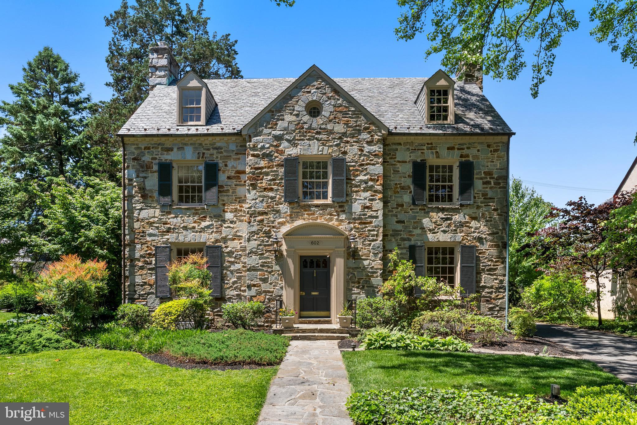 More photos to come! Stately Stoneleigh stone Colonial located on one of the most beautiful streets in the neighborhood! This timeless home offers incredible curb appeal, light-filled interiors, large rooms, and over 3,700 above-grade sq. ft., making it one of the largest homes in Stoneleigh. Opportunities to own a home of this size and character in the neighborhood are rare. One of the original homes built in Historic Stoneleigh, this classic center hall Colonial blends the elegance and charm of the 1940’s with thoughtful modern updates. Recent improvements include a renovated kitchen, refreshed bathrooms, refinished hardwood floors, fresh interior paint, re-glazed windows, new lower-level flooring, and freshly painted exterior shutters and doors (all completed in 2026).  A gracious foyer welcomes you into the home and is flanked by a spacious formal dining room and a sun-filled living room with a gas fireplace. Just off the living room is a stunning stone-lined sun-room featuring original stone walls and flooring, overlooking the private backyard and flagstone patio, a warm and inviting space perfect for relaxing, entertaining, or dining al fresco.  The renovated kitchen offers updated amenities while maintaining the home’s original character and charm. Throughout the home you’ll find classic moldings, original hardwood flooring, large windows, original shutters and front door details, and even a charming laundry chute.  The second floor features a spacious primary suite with an en-suite bath, along with two additional bedrooms connected by a Jack-and-Jill bathroom with an original cast iron tub. The third floor includes an additional bedroom with en-suite bath, closet space, and unfinished attic space with the potential to create one or two additional bedrooms.  The finished lower level adds approximately 750 square feet of living space and includes a large family room with a beautiful stone fireplace, workshop area, spacious laundry room, half bath, and ample storage.  Outside, enjoy the beautifully landscaped private backyard with mature trees, a charming fish pond, flagstone patio, and a stone detached two-car garage.  Living in Stoneleigh is about more than just the home, it’s joining one of Baltimore County’s most welcoming and engaged communities. Enjoy neighborhood gatherings, block parties, the community pool, and walk-ability to Stoneleigh Elementary, Dumbarton Middle School, and Towson High Law & Public Policy. Conveniently located near local restaurants, shops, the Stoneleigh bowling alley, ice cream shops, Towson Town Center, major commuter routes including I-695 and I-83, downtown Baltimore, and area hospitals.  Come experience the charm, character, and community that make this extraordinary Stoneleigh home truly special.