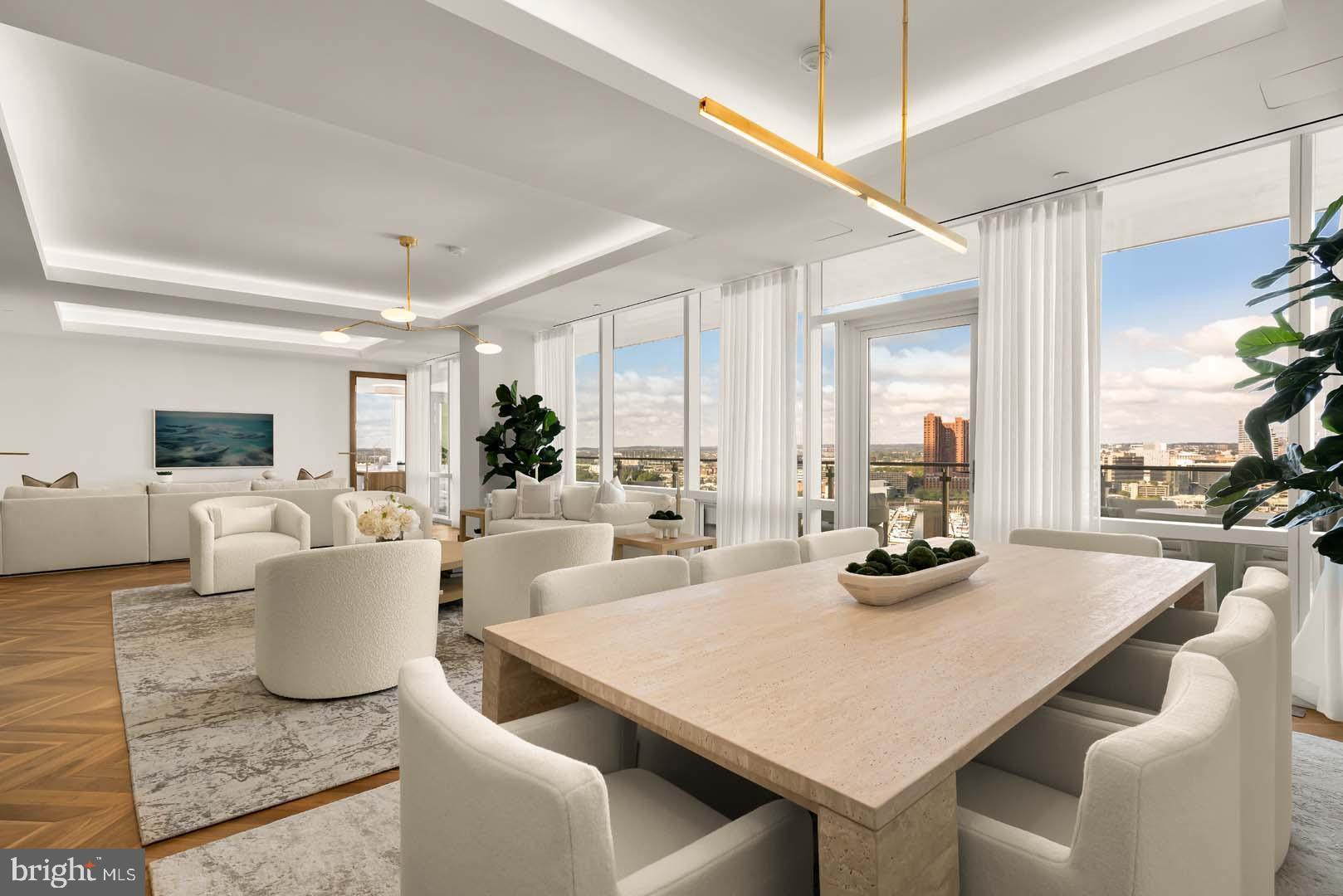 BRAND NEW SHOWCASE MODEL - TWO BEDROOM + DEN  + OFFICE W/ BALCONY AVAILABLE!
Welcome to the Four Seasons Private Residences in Harbor East, where luxury meets lifestyle in Baltimore’s most coveted waterfront address. This stunning two-bedroom, two-and-a-half bathroom newly furnished model comes with designated den and office spaces, and was thoughtfully designed to maximize every inch, making it live far larger than its 2,772 sq ft. Step into an atmosphere of sophistication with soaring ceilings, rich walnut chevron-patterned flooring, and curated designer finishes throughout. Expansive floor-to-ceiling windows flood the home with natural light and offer breathtaking views of the Inner Harbor and iconic Domino Sugar throughout. The open-concept living and dining areas flow seamlessly into a gourmet kitchen outfitted with Miele appliances, sleek Eggersmann soft-close cabinetry, luxurious marble stone countertops, and a built-in Sub-Zero wine fridge. Just steps away, a wet bar equipped with an ice maker and an additional wine fridge adds convenience and elegance, ideal for entertaining. The primary suite is a tranquil retreat, featuring a massive walk-in closet and a spa-inspired, marble-clad en-suite bath. Enjoy a double vanity with designer finishes, private water closet, glass-enclosed walk-in shower with a built-in bench and niche, and a sculptural freestanding soaking tub that invites total relaxation. A dual-access balcony (accessible from both the living area and the primary suite) offers the perfect perch to take in harbor views and fresh air. The spacious den provides flexible use as a library or media room, and the additional sun-soaked office space offers the perfect setting for productivity and inspiration. Every space is enhanced by motorized window shades and expansive views that change with the light.

The Four Seasons Private Residences Baltimore offers a turn-key elevated lifestyle. As a resident, you'll enjoy a private entrance where you will be met by our full service concierge and on-site building manager to assist with your every need, as well as exclusive access to the sprawling 28th-floor amenity level, where world-class services meet resort-style indulgence. Amenities include an indoor heated saltwater infinity-edge pool, a state-of-the-art fitness center, sauna, coffee station, billiard room, and numerous elegant gathering spaces. Multiple rooftop decks offer panoramic city and harbor views, complete with indoor and outdoor fireplaces, a grilling station, a dining area, and a kitchen, all ideal for entertaining. Additional perks include a fully equipped conference room and a dedicated AstroTurf dog-walking area. This residence offers the rare opportunity to live within a full-service, hotel-branded building while enjoying the privacy and sophistication of a true luxury home. All set within steps of Harbor East’s acclaimed restaurants, shopping, and the waterfront promenade. This is a MUST SEE TWO BEDROOM + DEN + OFFICE!! Immediate occupancy is available. Come see what all the fuss is about!