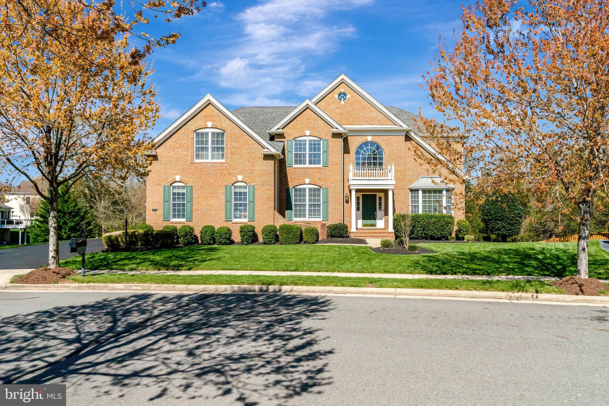 Absolutely Immaculate brick front open space concept Harvard Model in resort style gated Dominion Valley Country Club!  .  *  Upgrades include Adding 1894 Sq Ft of Finished Basement with Full Bath, an extra Bedroom, Luxury Bar,  Upgraded all baths and light fixtures, Upgraded Kitchen, Custom shelving and granite counter tops in Laundry room, Added custom shelving in Garage And All Bathrooms * 5BR/5BA Approx 5844 Sq ft of Finished space  with  3 Car Side loading Garage * Formal Living Room with a bay window * Separate Dining Room * Large gourmet Kitchen boasting granite counter tops, elegant tile backsplash, upgraded SS appliances, Breakfast Bar * Sunroom Addition * Breakfast Room * Expanded Two-story Family Room featuring a gas Fire Place and stylish coffered ceiling * Home Office * Gleaming wide plank wood floors on main lvl, staircase and upper level hallway * Upgraded light fixates  *  Amazing Owner’s Suite boasting a tray ceiling, a sitting room and 2 large walk-in closets * Luxurious Owner’s Bath with separate vanities and upgraded tiles * Princess Suite w/ a full bath * 2 Bedrooms and a Jack & Jill Bathroom * Amazing walk-out basement featuring a large rec room, a bonus room/gym, a full bath plus tons of storage * Nice backyard overlooking green space and a Pond * Community features World-class amenities: Arnold Palmer Signature Golf Course, renovated Clubhouse, state-of-the-art Sports Pavilion, 5 swimming pools including an indoor pool, tennis & basketball courts, playgrounds, miles of walking/biking trails and two fishing ponds * Award winning schools!