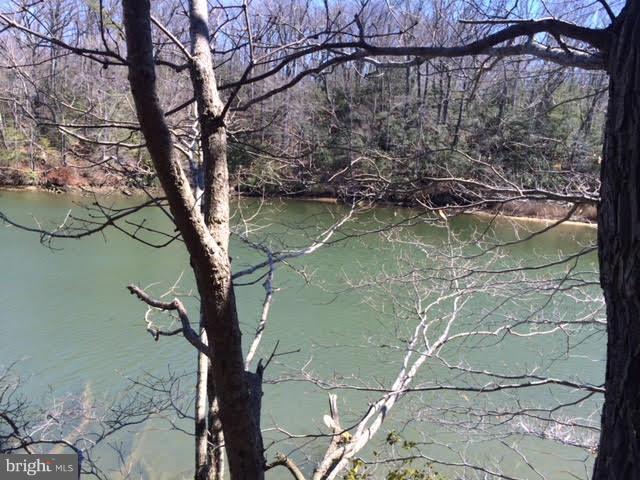 Rare Opportunity - This 24-acre waterfront lot  has many special features. The views are Spectacular!  Located on Lewis Creek, this creek was dredged in the 1960's for a marina across from this property that didn't materialize so there is plenty of depth.  This lot is perc'd and ready for your home. Located in the neighborhood of Town Creek it is close to shopping and the Navy Base