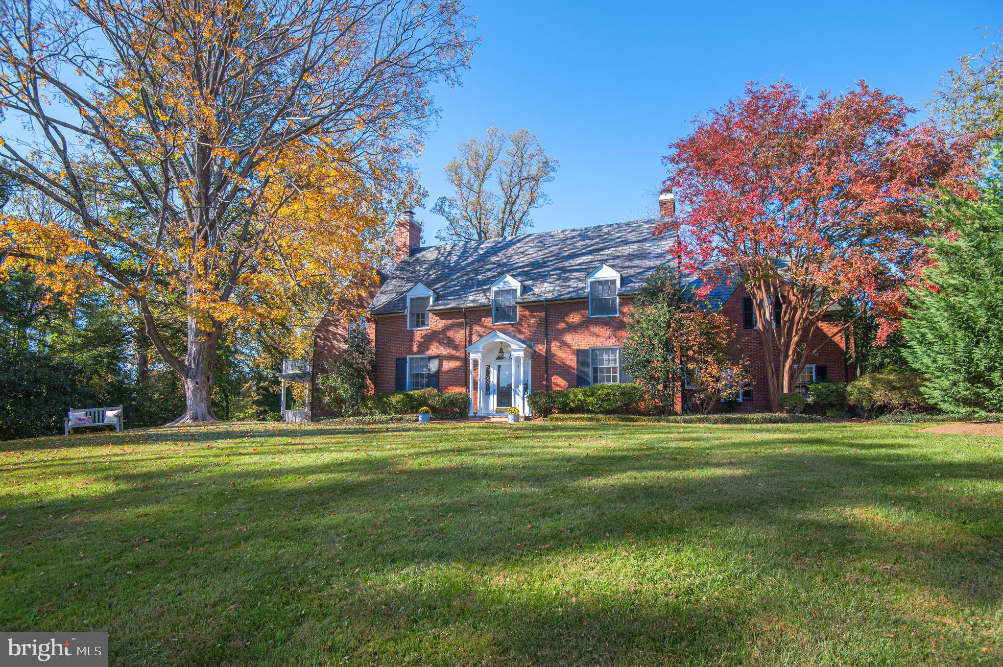 Graciously situated on 1.6 acres. This classic colonial offers generous living spaces with enchanting views. Over 5300 sq ft.  5 BR, 4/3 BA.  Exceptional details include hardwood floors,built-ins, & millwork. Oversized family room with fireplace, wet bar & French doors to fabulous southern covered porch. Formal dining room & living room with fireplace & built-ins. Spacious eat-in kitchen with breakfast area. Convenient 1st floor laundry & mudroom. Fabulous primary suite with sitting room, spa bath, multiple closets, vaulted ceiling & private balcony overlooking gorgeous grounds. Second floor includes  4 additional bedrooms and 3 bathrooms (one can be used as an in-law suite with private stairway). Bonus 3rd Floor Loft/Office.  Great family/game room in the finished lower level with half bath & outside entrance.  All saw-tooth brick exterior, blue stone patio with brick seating wall and accent lighting. Expansive landscaped yard and patio offer privacy and lots of room for outdoor entertaining. Meticulously maintained.  Updates include A/C and new gas boiler. Tranquil setting in premier Ruxton location. You will always look forward to going home!