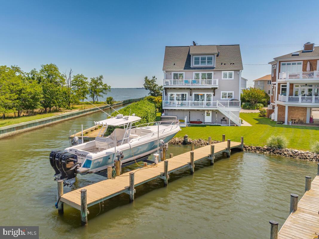 Stunning Waterfront Coastal Retreat on Oyster Creek with Breathtaking Sunsets! This exceptional 4-bedroom, 4-bathroom home is perfectly situated on the shores offering unique views of the Chesapeake Bay and Oyster Creek from nearly every room. Step inside to discover the open design, highlighting a gourmet kitchen designed for both beauty and function, featuring granite countertops, stainless steel appliances, and breakfast bar. The open-concept living and dining areas flow easily out to the multi-level waterfront decking, ideal for entertaining or simply enjoying the peaceful surroundings. The luxury primary suite is a true sanctuary, complete with a private waterfront deck, spa-like bathroom featuring a walk-in shower, soaking tub, and a generous walk-in closet. The third-level living space includes a full bath and offers endless possibilities—perfect as a media room, guest suite, or home office with elevated views.
Outside, a private pier with a 20,000 lb boat lift invites you to explore the water with ease. Whether you're boating, fishing, or just soaking in the serene creekfront setting, this property offers the ultimate coastal lifestyle. Don’t miss this rare opportunity to own a slice of waterfront paradise on Oyster Creek. Property is in a Special Tax District. - $2,274.75 annually.