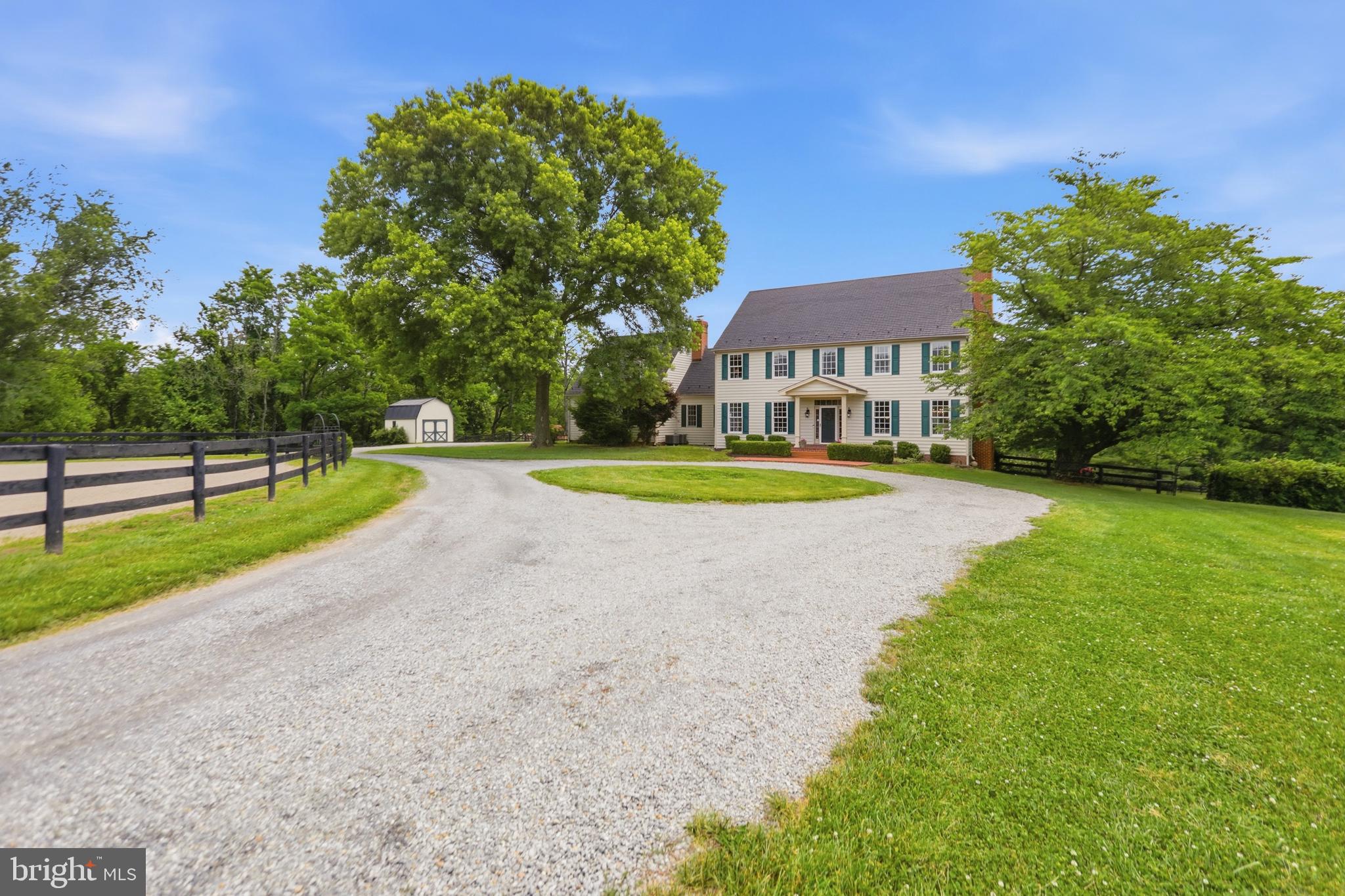 This custom colonial home is situated on 10 enchanting acres of rolling pastures, woods, creeks, mountain views, and historic stone walls. With 9-foot ceilings, multiple fireplaces, dark hardwood floors, and a slate-style roof, this 1980s residence was thoughtfully designed to capture the character, charm, and timeless appeal of a true historic estate. The acreage is divided into roughly 6 acres of horse pastures and 4 acres of woods, creeks, and yard. Thoroughly fitted for equestrian needs, the property offers a 4-5 stall barn with a full tack room, and wash stall (with hot and cold water), an automatic waterer, and a sand and bluestone ring. A wonderfully maintained diving size pool is situated in the backyard, completed by a cabana and extensive landscaping. The location is tucked away into Bluemont’s incredibly private landscape, yet still within a couple of miles to multiple wineries, breweries, farms, and country stores. Estimated active list date of July 16th.