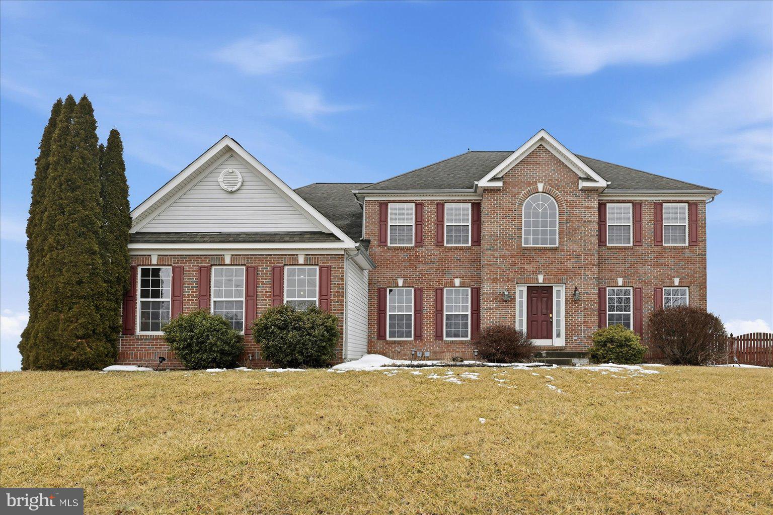 LOCATION, LOCATION, LOCATION! Welcome to 693 Spruce Hill Way in the highly sought-after Spruce Hill Estates community of Charles Town, WV — a spacious and versatile home perfectly designed for comfortable everyday living and multi-generational flexibility. Ideally located with convenient access to Rt. 340, Rt. 9, and Washington High School, this property offers both privacy and accessibility while sitting on a beautiful 1.44-acre lot.

This impressive home features four bedrooms and four and a half bathrooms with a thoughtful layout that provides space for everyone. The large kitchen showcases granite countertops and ample room for gathering, entertaining, and daily living. The expansive owner’s suite offers a relaxing retreat, while a private guest room with its own full bathroom creates the perfect setup for visitors or extended family. Bedrooms three and four share a convenient Jack and Jill bathroom, adding both functionality and comfort.

The living space is enhanced by a fireplace, ready for cozy evenings, and a mostly finished basement with durable concrete tile flooring, a full bathroom, and excellent potential for a future full kitchenette (currently there is a great start with a wet bar) — making it ideal for multi-family or multi-generational living arrangements. Step outside to enjoy the  deck overlooking the fenced backyard, perfect for outdoor entertaining, pets, or peaceful evenings at home.

Additional highlights include an oversized three-car side-entry garage, a Vivint alarm system for added security, and more. The roof was inspected just 1.5 years ago, offering added peace of mind to future homeowners.

Combining a beautiful brick home with a great flow and an exceptional location, this home delivers comfort, flexibility, and opportunity in one of Charles Town’s most desirable neighborhoods.