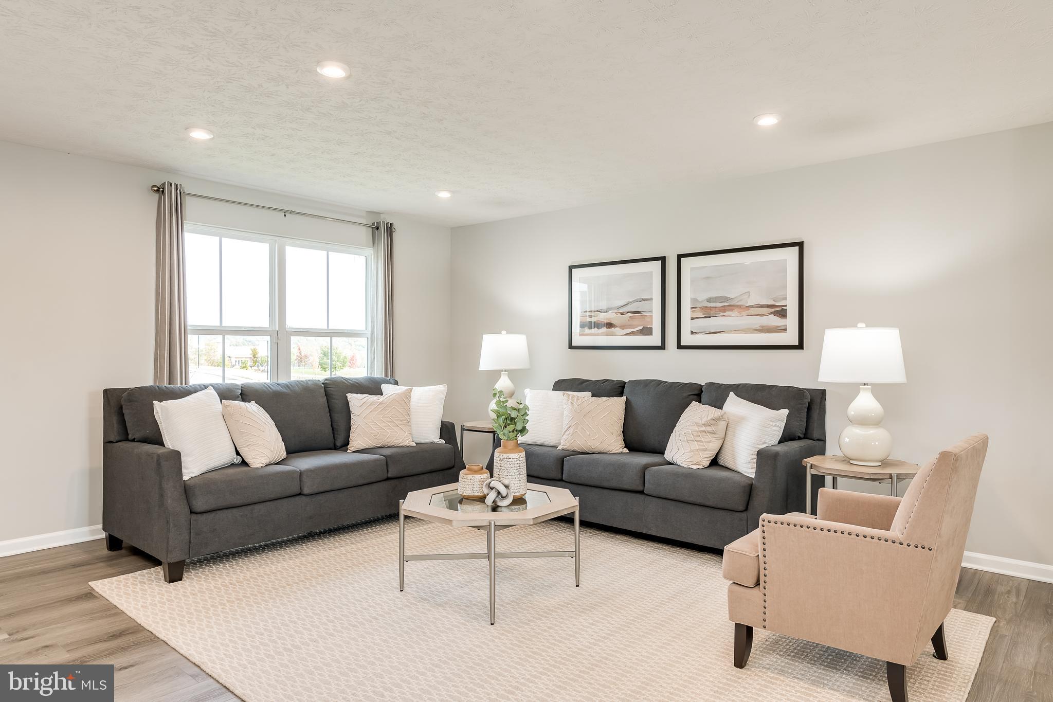 To‑be‑built Elder plan at the Oak Leaf Meadows community! The Elder truly has it all, offering 2,203 finished square feet, 4–5 bedrooms, 2.5 bathrooms, a 2‑car garage, and a versatile upstairs loft.
Step inside to an open‑concept main level featuring a spacious great room that flows seamlessly into a gourmet kitchen with brand‑new appliances, abundant cabinetry, and an oversized island overlooking the dining area—perfect for entertaining or everyday living. Just off the garage entry, a flexible bonus room and conveniently located powder room create the ideal space for a home office, hobby room, or play area.
Upstairs, you’ll find three additional bedrooms—two with walk‑in closets—along with a full hall bath, second‑floor laundry, and a cozy loft that’s perfect for a media room or additional gathering space. The loft can also be converted into a fifth bedroom for even more flexibility. The owner’s suite is a true retreat, featuring a luxurious dual‑vanity bath and two walk‑in closets. An unfinished basement offers ample storage with endless possibilities for future living space.
Oak Leaf Meadows offers an exceptional location in the Musselman School District—just 5 minutes to I‑81, 15 minutes to Martinsburg, and 20 minutes to Winchester. Closing assistance available with the use of the seller’s preferred lender. Lot premiums may apply. Other floorplans and homesites available. Photos are representative.
Visit the model home at 186 Inola Court, Inwood, WV 25428, and discover The Elder today!