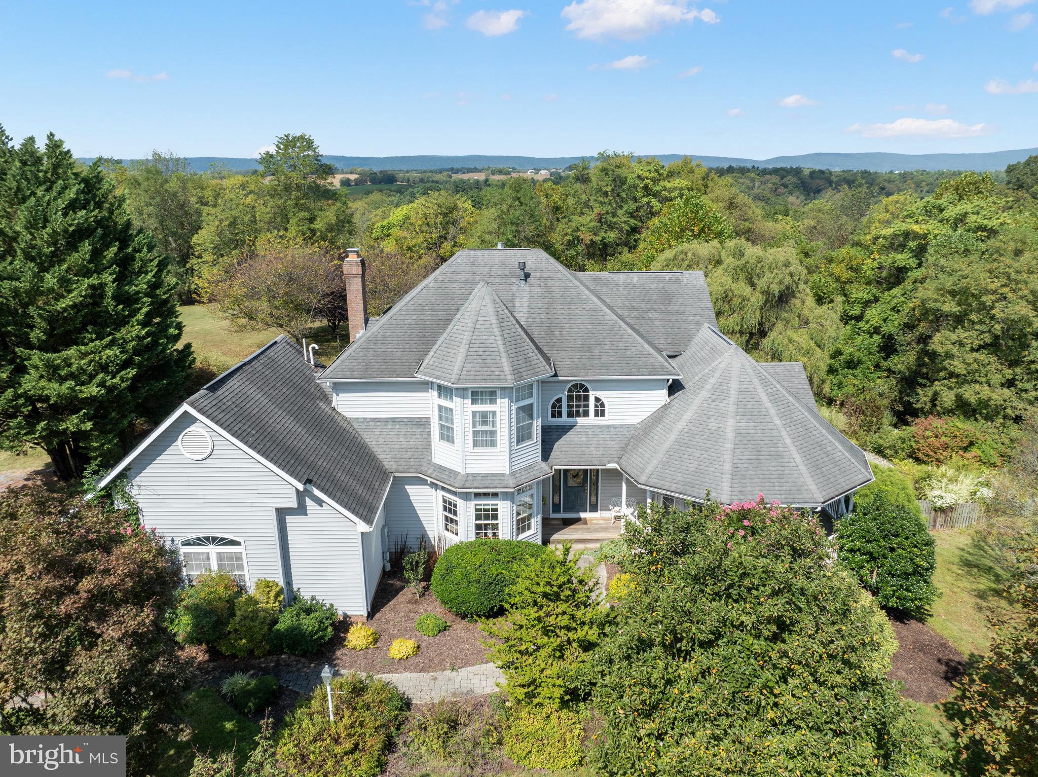 This unique home sits on 11.5 rolling acres and was custom built by the current owners.  With sunrise views from the primary bedroom and sunsets off the back porch, nature shines beautifully every season.  The house is filled with natural light from ample windows and the layout is thoughtful and open.  Whether you enter from the front door or the attached garage, you're met with hardwood floors and comfortable spaces.  There are 3 bedrooms upstairs with  2 full bathrooms.  The main level laundry is down the hall from the large kitchen, and a main level 4th bedroom gives you many options.  You can enjoy the outdoors from multiple decks and porches, as well as the pool-side patio.  The house is surrounded by sprawling yards that turn to forest the farther you get away from the house. The 40'x30' pole barn is large enough to park an RV, tractor, or convert to many other uses.  Part of the lot is in Forest Preservation, buyers to confirm easements and restrictions of use.  In-ground pool is hard surfaced, not a vinyl liner, and was resurfaced and recaulked about 4 years ago.   The pump and mechanisms were replaced about 5 years ago and are in good working order.  Depth goes from 3' to 8' with stairs at the shallow end.
