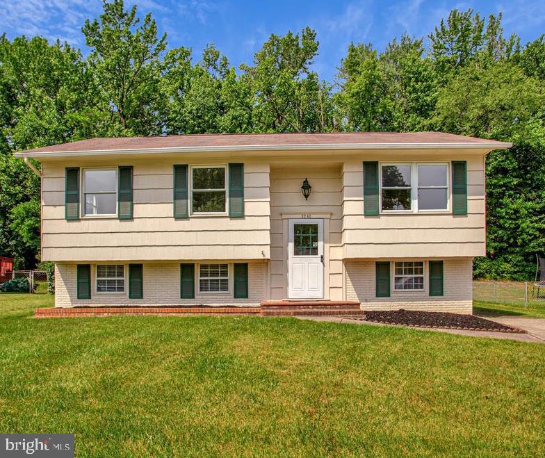 Welcome home to this charming 3-bedroom ready to move in split-foyer featuring fresh paint, brand-new carpeting, and new lighting throughout. The country kitchen offers a gas stove and convenient walkout access to the deck, making it ideal for both everyday living and entertaining. Enjoy wooded views from the deck just off the kitchen. The lower level features a cozy family room with classic wood paneling, providing the perfect space for relaxing or shooting pool with friends and family. A fully renovated full bath adds modern style and convenience, while the large storage and utility area includes a workbench, laundry space, and plenty of room for hobbies, projects, and organization. Combining tasteful updates, functional living spaces, and a serene natural setting, this home is ready for you to move in and enjoy.