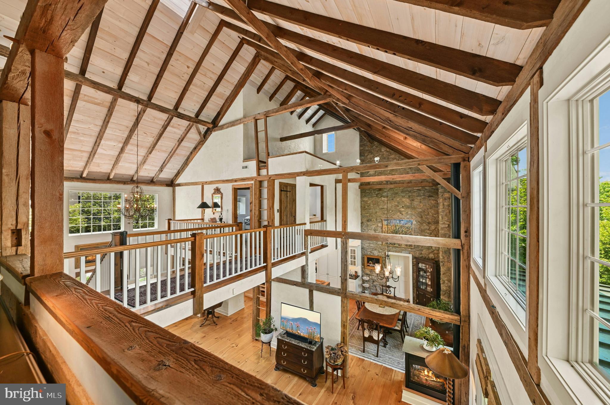 This amazing property is just steps away from the renowned Saucon Valley Country Club. Welcome to marvelous architectural features at every turn. This Saucon Valley home’s extraordinary character evolved from a legacy barn restored into a unique residence that boasts the best of old and new … combining space, light and imagination.
Inside, warm wood flooring, custom doors and cabinetry, exposed posts and beams, cathedral ceilings and stunning window placement set the mood for a perfect retreat that redefines the meaning of barn conversion. The main floor is boldly open and yet delivers an intimate warmth with a fabulous, white, gourmet kitchen. The flow between the spacious rooms is inviting and free. A first floor master bedroom suite, with fabulous bath, is a romantic oasis. Two additional 2nd floor bedrooms and an office are distinctive, with vaulted, beamed ceilings and dramatic window placements. Finally, the expansive
lower level provides a family room, guest room and full bath and doors to the outside in every room.
A covered deck and covered patio with fireplace are surrounded by magnificent gardens that bloom all year round. This magically private property is just minutes from the Promenade shops, convenient to I-78 and under 90 minutes to NYC. Relax amidst your beautiful gardens or play a round of golf and dine at the world class Saucon Valley Country Club.