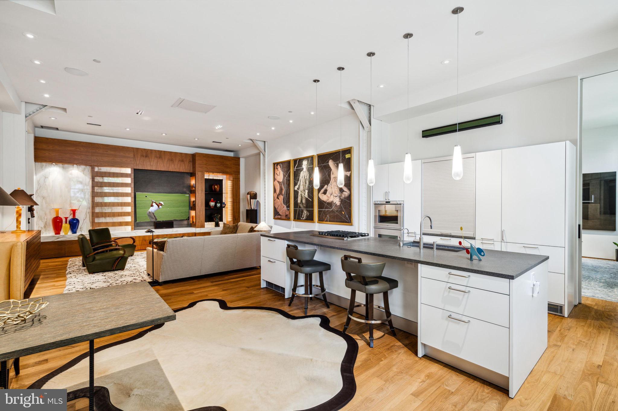 Welcome to 227 S 6th Street Unit 1C, a one-of-a-kind 2,752 SF residence that adapts to any lifestyle. This luxury condo offers the flexibility to maintain its current layout or completely reimagine the floorplan to suit your needs.

You can enter through a private, pedestrian-only walkway just steps from Washington Square Park, providing the privacy of townhouse living without exterior maintenance, or through the doorman entrance of the boutique Lippincott Building for secure package receipt and controlled entry. No other condo combines parkside townhouse privacy with full-service luxury.

Inside, the grand foyer boasts 14-foot ceilings, limestone floors, and artisan plaster walls. Currently a dining room, this versatile space can be transformed into a formal living room, family room, receiving foyer, or multi-use space such as an office/den/mudroom hybrid.

The adjacent great room offers a spacious open floor plan where you can choose to combine kitchen, dining, and living all-in-one for entertaining, or create more of a focus in its utility. Featuring calcutta gold marble, a walnut bookcase/entertainment wall, a chef's kitchen with Gaggenau and Miele appliances, basalt counters, double dishwashers center island, and a conveniently located half-bath, this space combined with the great room gives you more than enough square footage to configure the primary living space for your lifestyle needs.

The two generously sized bedrooms feature en suites and customizations. The primary suite includes a custom walnut bed, sitting area, retractable TV, and European bath. The second bedroom, currently a den/bedroom hybrid with built-ins and wet bar, can be used as a guest suite or easily reconfigured into two bedrooms, making this a 3-bed unit.

Modern conveniences include TWO-CAR PARKING, both spaces are EV charging-enabled, 2-zone HVAC, Lutron lighting control, and warehouse sized windows with Smartint capability that run the length of the residence and face south for extraordinary natural light.

This unit is offered turnkey, fully furnished, (excluding art) and ready to be your modern metropolitan oasis. Designed by architect Stephen Verner, it seamlessly blends contemporary design with high-end natural finishes. With one-floor living, two parking spaces, full-service amenities, and flexible entry options, this residence offers everything you need, with the freedom to evolve with your lifestyle.