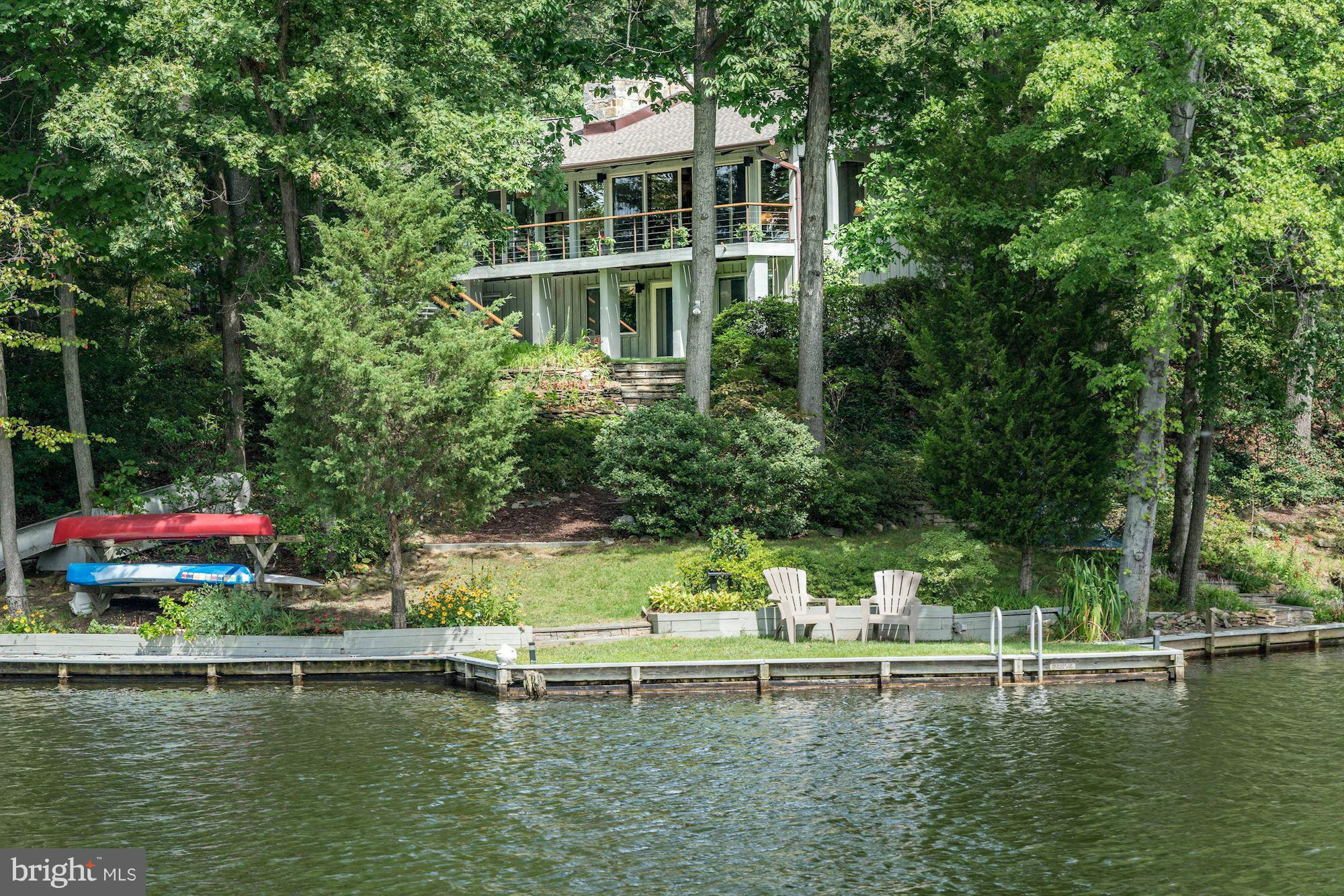 Located on a preeminent 3/4 acre lot with 374 ft of waterfront & panoramic views. Hot tub & private dock for recreation. Fully renovated home w/ cathedral ceilings, wood floors & luxury updates throughout. 6BR/4.5BA, gourmet kitchen, 4 fireplaces, formal dining/living room, family room, recreation room. Private, well-landscaped yard. See Virtual Tour. Approx. 7 Miles to Washington, DC.