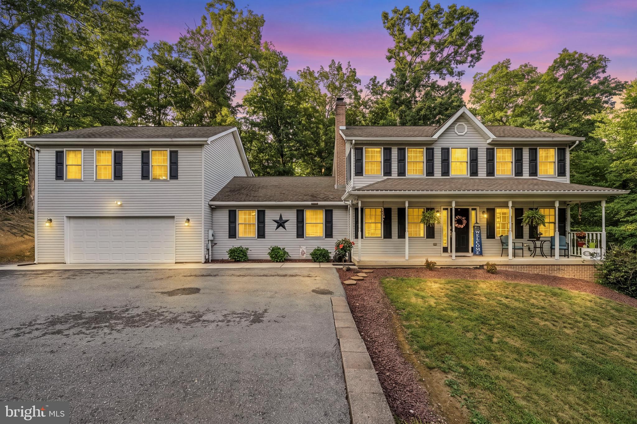 Welcome to this beautifully updated home situated on 3.15 private acres in Falling Waters! Offering the perfect combination of space, comfort, and versatility, the main residence features 4 bedrooms, 3.5 bathrooms, and an additional flex room currently used as a home gym, providing endless possibilities for a home office, playroom, or hobby space. The separate in-law suite includes its own private entrance, kitchen, living room, spacious bedroom, walk-in closet, full bathroom, and private deck—ideal for multigenerational living, extended guests, or potential rental income. The oversized garage offers ample space for vehicles, storage, or even a boat. Recent updates include a 2023 Trane XR14 heat pump system, a stunning 2025 primary bathroom remodel, new shutters, all new Samsung stainless steel appliances including the refrigerator, oven, microwave, and dishwasher, plus new granite countertops and tiled backsplashes in both the main home and the in-law suite. Enjoy the privacy of country living without sacrificing convenience, located just minutes from I-81 and I-70, approximately 15 minutes from Spring Mills Elementary, Middle, and High School, Berkeley Medical Center, and Hagerstown, with Meritus Medical Center just 25 minutes away. This exceptional property combines modern updates, flexible living space, and an unbeatable location to create the perfect place to call home.