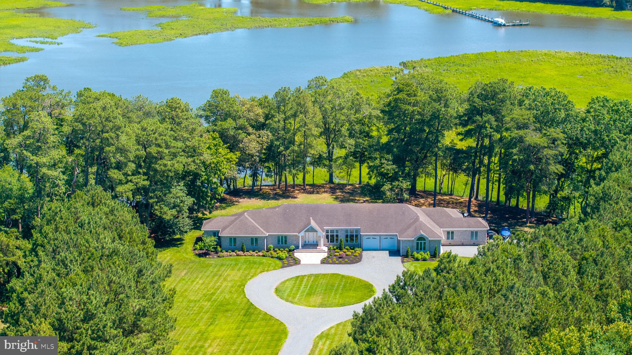 Palatial High-Elevation 5-Acre Waterfront Estate: 5,600 SF All-Brick Rancher with In-Law Suite
Please view the Fly-Through Video!
Sprawling across five acres of high-elevation land along Wicomico Creek, this magnificent 5,600-square-foot, single-level all-brick rancher delivers an elite waterfront lifestyle. A long, stately driveway draws you past a perfectly manicured lawn and professionally landscaped grounds, creating a dramatic sense of arrival and absolute coastal privacy. The estate boasts premium proximity to the prestigious Wicomico Yacht Club and the scenic vineyards of Bordeleau Winery, offering an incredible maritime backdrop.
Masterfully designed for the ultimate boating lifestyle, the waterfront features a private deep-water dock equipped with two boat slips. This setup provides effortless, unrestricted deep-water access, making it easy to cruise straight into the Wicomico River and out to the Chesapeake Bay and beyond! Complementing the maritime design is a massive four-car attached garage, providing abundant space for vehicle collections, water toys, and winter marine storage. 
Inside, the grand tour begins in the large, cathedral foyer, the true heart of the home. This dramatic entryway showcases custom floor tile, stately columns, and a magnificent Schonbek crystal chandelier that casts a brilliant glow over the entrance. From this central point, the home flows effortlessly into main living spaces where elegant tray ceilings add architectural depth. Soaring walls of glass frame breathtaking, panoramic water views from your high-elevation vantage point, while two cozy gas fireplaces add warmth and elegant focal points to these grand spaces. The culinary core features two separate, custom Quaker Made gourmet kitchens outfitted with high-end appliances, making this property unmatched for hosting grand gatherings.
The single-story layout showcases six spacious bedrooms and 3.5 bathrooms, cleverly divided into two distinct wings. A beautiful, architecturally integrated breezeway separates the two living quarters, offering a peaceful, private transition into the fully independent in-law suite, which utilizes the second Quaker Made kitchen. This rare combination of acreage, high elevation, custom design, and premier deep-water dock access represents a once-in-a-generation opportunity. Located just a few hours from the DC and Baltimore metro areas and an hour from Ocean City and Assateague and other area attractions! Extensive Features Document available.
Schedule a private tour of this fabulous estate today!