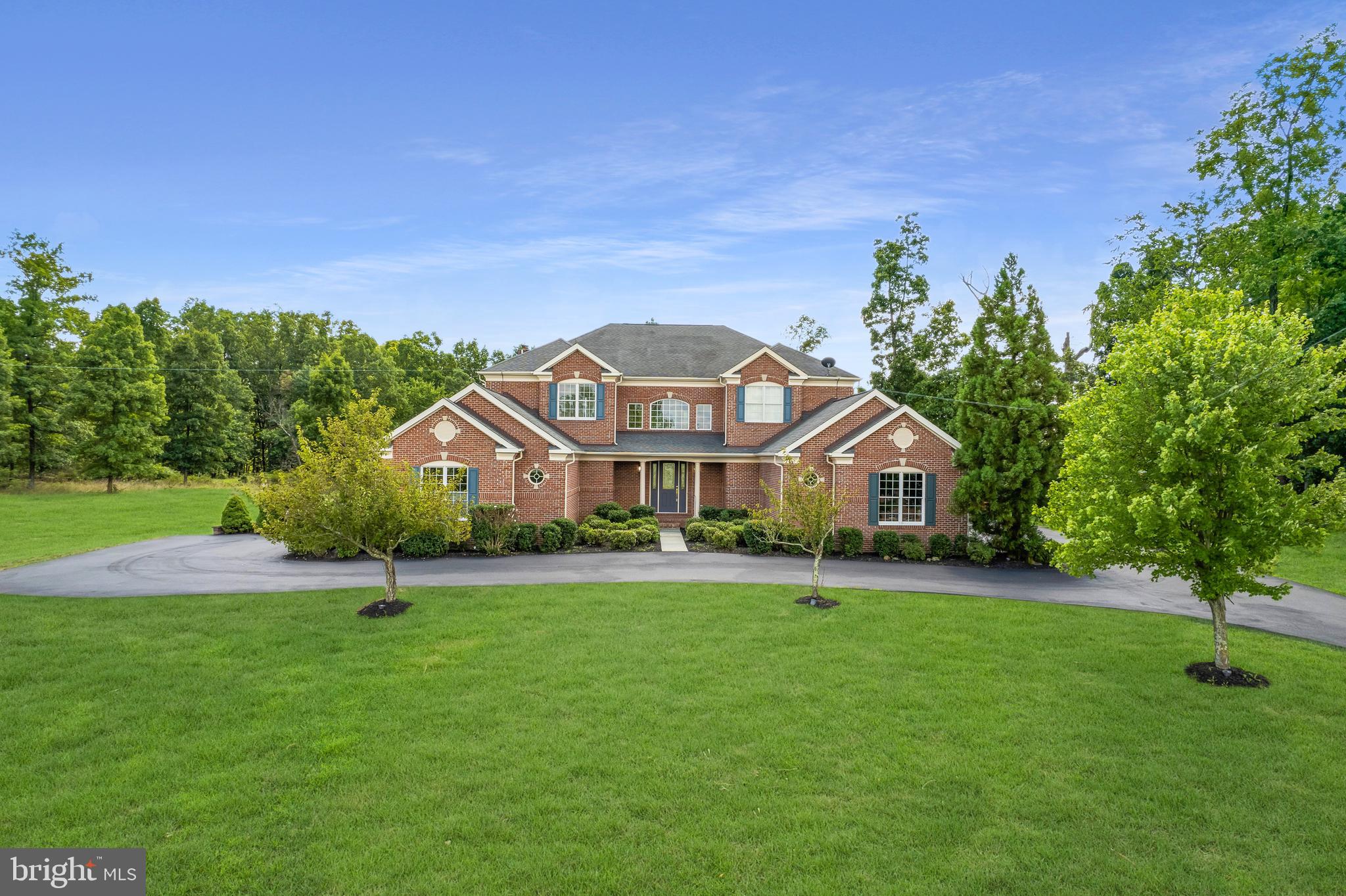 Welcome to your dream home in The Estates of Shenstone Farm. Perched atop a hill and facing north, this impressive executive home built by Toll Brothers offers stunning mountain views and a beautiful wooded backyard from its expansive 5-acre lot. This residence boasts over 8,000 square feet of luxurious living space, including five bedrooms and four-and-one-half bathrooms.

Key features include:

Main Level Bedroom and Full Bath
Four-car garage with car lifts, perfect for car enthusiasts
North-Facing
Newly - Paved Driveway
Grand two-story foyer
Formal living and dining rooms
Main level primary suite with a spacious walk-in closet and adjacent office
Expansive lower level with a Recreation/Game Room and full bathroom
Sheltered screened-in patio for evening relaxation

The elevated ceilings create a grand atmosphere, perfectly complementing the breathtaking views. The meticulously designed main level seamlessly blends luxury with functionality. The extraordinary lower level provides an ideal space for guests, with abundant storage and opportunities to make the space your own. Spend your evenings unwinding in your backyard sanctuary, enjoying the privacy and serenity of your sheltered screened-in patio.

Why build new when you can move into this updated dream home with 5 acres of privacy? Don't miss this unique opportunity to own a piece of paradise in Shenstone.