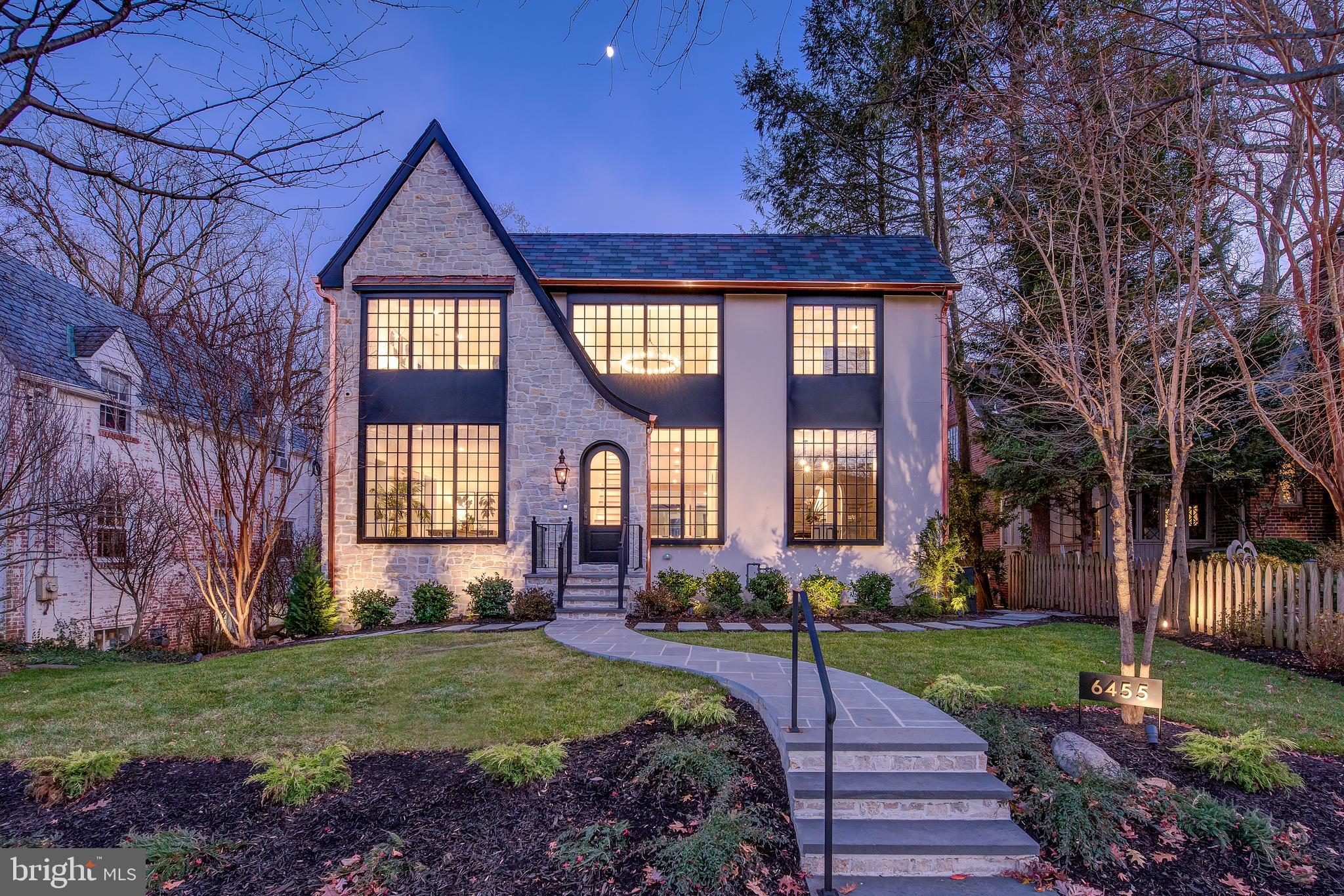 Modern lines and traditional Tudor elements combine seamlessly in this five bedroom, five and a half bathroom estate situated on a manicured lot in Barnaby Woods.  Enter into a two-story foyer, complete with a stunning chandelier, and take in the unique features of this home including solid 6â live sawn white oak flooring from Brick & Board, arched doorways and soaring ceilings.  Celebrate any occasion in the formal dining room complete with wood paneling painted in Sherwin Williams Color of the Year, Urbane Bronze.  No detail was overlooked in the kitchen featuring rows of rich custom cabinetry, individually selected Calacatta Vagli marble slabs and Jenn Air appliances including an Obsidian refrigerator and Pro Range.  A butler's pantry with a beverage cooler and prep sink provide additional storage.  An inviting family room, private home office, separate Zoom room and powder room complete this level. 

Follow the floating staircase with live sawn oak treads to the lower level complete with polished concrete floors.  The two-story great room draws you in with a wall of windows overlooking the wooded backyard.  The high ceilings create an open and airy atmosphere anchored by a wood-burning fireplace, carved stone mantel, wet bar and wine cellar.  A flexible media room/gym and a guest suite with a walk-in closet and private entrance complete this level.  Four bedrooms are on the upper level including the luxurious owner's suite featuring a private balcony overlooking the backyard.  The marble tiled bathroom offers a Brizo dual shower, soaking tub, double vanity and custom walk-in closet. Interior and structural warranties offer additional peace of mind.

The same attention to detail can be found on the outside of this home where custom windows compliment the natural tumbled limestone facade from a Wisconsin quarry.  A unique Mahogany arched front door and gas lantern add to the stunning curb appeal of this estate.  A stone walkway leads through the manicured landscaping and into the backyard.  

Relax or entertain on the large stone patio offering plenty of room for seating.  The patio is surrounded by green space and wooded views for additional shade and privacy.  Custom lighting fills the backyard for easy enjoyment any time of day.  Enjoy both quiet and convenience...Chevy Chase DC's shops and restaurants and all points DMV are just moments away.