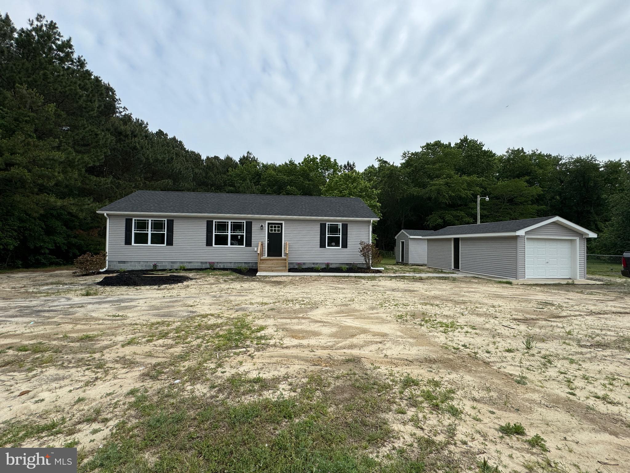 NEW Construction rancher style home in Lincoln, De on beautiful  0.57 acre secluded lot backing up to a tree line. Expected completion is 30days from ratified contract. Gravity septic to be installed. Interior photos are of another location but same model. This 3 bedroom home has 2 full bathrooms, spacious living room & separate laundry room. The builder is offering a stainless steel kitchen appliances package as well as granite countertops. This home would be great for a first time buyer, second or vacation home or airbnb. Only 15-20 min drive to Lewes beaches & 5-10 min to Broadkill Beach. HVAC system is American standard, faucets are Moen, carpet in bedrooms and vinyl flooring in kitchen, living room and bathrooms. Kitchen cabinets will be white or light gray  / 15 Hampton Bay. Kitchen island is optional. Open floor plan! Gravel driveway, a new shed & a one car detached garage are added bonus for the new homeowner.  Check out this great open floor plan rancher home & schedule your showing now!