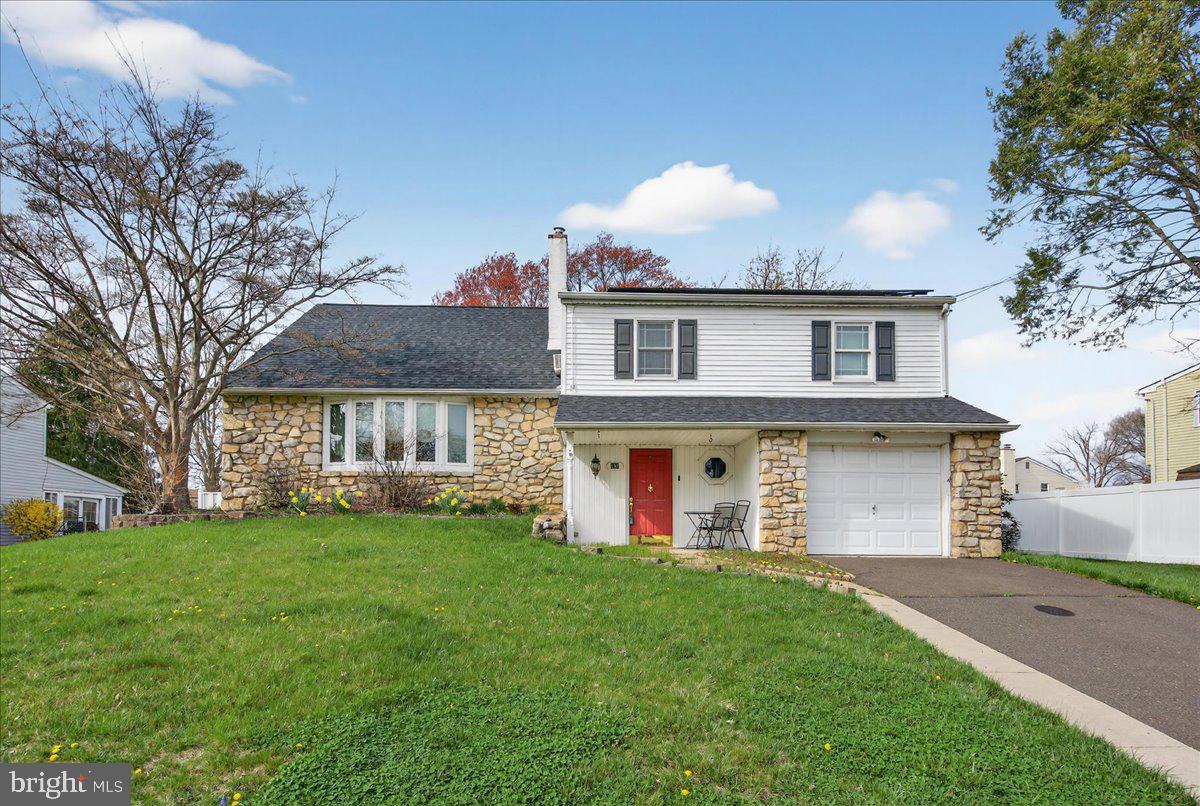 Opportunity knocks! This spacious 4 bedroom, 2.5 bath stone-front home is full of potential and ready for your vision in a wonderful neighborhood within walking distance to Eleanor Roosevelt Elementary School. A covered front porch welcomes you into the entry foyer with coat closet. The main level offers a functional layout featuring a family room with a brick fireplace with brick hearth, built-in storage on both sides, and unique octagon accent windows. Seller does not know of any issues but is selling the fireplace as decorative, non-functioning. A triple window overlooks the large enclosed porch, bringing in great natural light. Additional main floor highlights include a powder room, laundry/utility room, a living room with bay window, and a formal dining room with dental crown molding and chair rail. The kitchen includes stainless steel appliances, a pantry cabinet, and a convenient pass-through to the family room. Upstairs, the main bedroom features a lighted ceiling fan, closet with shelving and private bath with fully tiled shower and glass doors. Two additional bedrooms, both with ceiling fans, share a full hall bath. There are two linen closets plus pull-down attic stairs for extra storage. A large fourth bedroom offers additional space with closet, storage tucked into the eaves and additional attic access. Additional features include a one car garage, solar panels, a fully fenced yard, economical gas heat with humidifier, gas hot water heater, convenient to shopping, commuting via Rts 1 & 95, PA & NJ Turnpikes and trains to NY & Philadelphia.