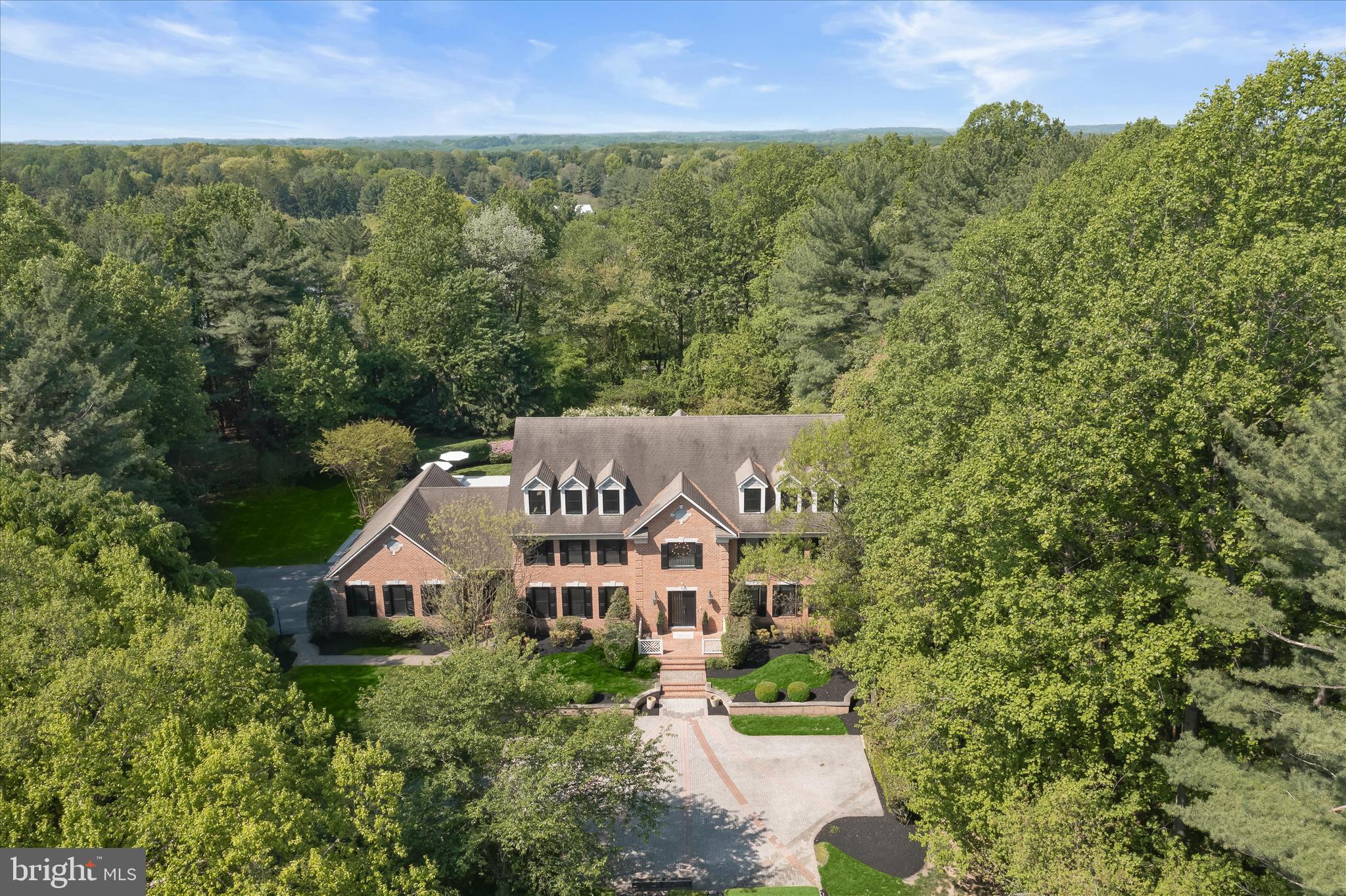 Iconic Estate | Hedgerow Estates – Clarksville’s Most Exclusive Enclave
Set on 3 acres of exquisitely curated grounds, this over 9,000 sq ft custom estate offers a rare combination of scale, craftsmanship, and resort-caliber living. Nearly $1 million in transformative upgrades have elevated the home to a level of finish and lifestyle seldom found in the market. A grand arrival begins with an expansive front courtyard, while the rear grounds showcase artfully designed French gardens, extensive hardscaping, and a newly built pool and spa, creating a private retreat ideal for both entertaining and everyday luxury. Residents also enjoy exclusive neighborhood amenities including a private tennis court, bike path, and tranquil lake. Inside, the home spans four fully finished levels with 8 bedrooms and 8 bathrooms, blending timeless architecture with modern sophistication. Features include new custom windows and doors, new wide plank matte hardwood floors, beautifully updated bathrooms, bespoke millwork, and luxurious custom lighting throughout. The updated chef’s kitchen is equipped with premium appliances, including a Sub-Zero refrigerator, while the main-level primary suite offers a spa-inspired bath and dual custom closets. The newly reimagined lower level rivals private clubs, featuring a wine cellar, entertainment bar, expansive recreation spaces, and a custom wellness center with gym and spa-like amenities. The rare fourth level adds exceptional flexibility with a second large executive office, lounge space, and private au pair suite. A one-of-a-kind estate where architectural presence, meticulous upgrades, and resort-style amenities converge in one of Howard County’s most coveted settings.