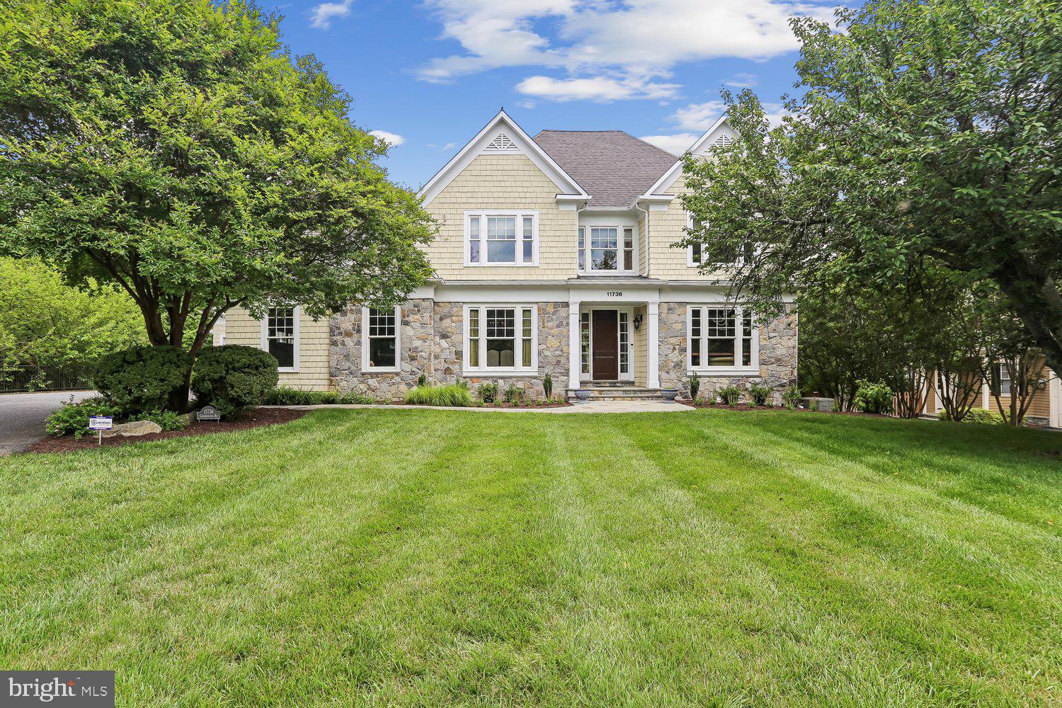 Welcome to a rarely available private oasis in Willerburn Acres. This beautiful home at 11736 Gainsborough Road offers 6 bedrooms, 4 full baths, and 2 half baths, a masterclass in scale and comfort. Built in 2005, this residence offers over 6,900+ square feet of interior, the quality of craftsmanship is undeniable, with thoughtfully designed living space on a lush three-quarter-acre lot. From high ceilings and gleaming hardwood floors to custom built-ins and abundant storage in every corner, it’s clear no detail was overlooked in the home's design and construction.

The heart of the home is a gourmet kitchen built for the serious entertainer. This culinary powerhouse features granite countertops, ample cabinetry, and a high-end stainless-steel appliance suite that includes two dishwashers, double ovens, two fridges/freezers, two sinks, and two warming drawers. Whether you’re hosting a holiday dinner in the expansive formal dining room—complete with a butler’s pantry—or a casual hangout in the family room with its elegant coffered ceilings and integrated shelving, the flow is effortless. For quieter moments, the main level also hosts a handsome library, two convenient half baths, and a coveted primary suite, providing a peaceful retreat complete with massive walk-in closets that make organization a breeze.

Practicality meets luxury in the home’s functional spaces, including a dedicated mudroom with its own side entrance—perfect for keeping daily life organized. It’s conveniently near a laundry room that boasts cabinets and storage galore. Upstairs, you’ll find four generous bedrooms, each with its own walk-in closet, connected by Jack-and-Jill bathrooms. The walk-out lower level continues the theme of intelligent design, offering a massive recreation room, a private office, a gym, an additional bedroom, and a full bath.

The transition between indoor and outdoor living is seamless, with the sprawling, park-like backyard accessible from multiple points throughout the house. Enjoy your morning coffee on the screened-in porch or host summer BBQs on the patio while taking in the greenery of your nearly three-quarter-acre lot. With a three-car garage and a location minutes from top-rated schools, the Cabin John Trail, and premier shopping, this home offers a rare balance of seclusion and convenience. It’s not just a house; it’s the lifestyle you’ve been waiting for.
It’s a rare find to stumble across a home that feels so impressively grand while staying so warm and peaceful.