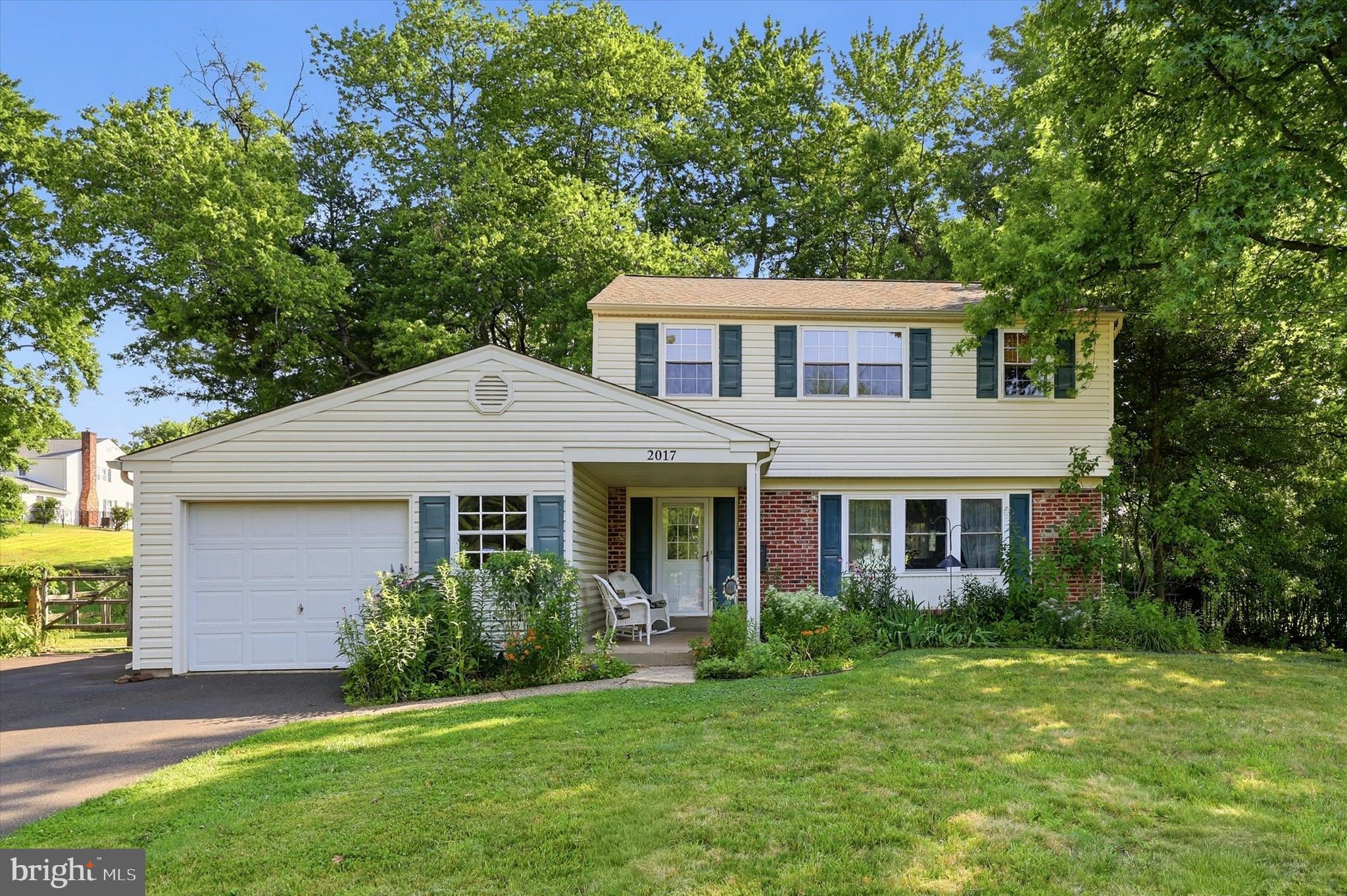 Tucked away in Warrington’s Palomino Farms, this 3BR 2.5BA porch front colonial sits on a treed lot and many PA native plantings with a generous sized fenced-in back yard and is nestled in the development just a short walk from Barclay Elementary School. This home has been beautifully maintained and is ready for you to move in and enjoy. There are hardwood floors throughout much of the home, and a partially finished basement adds some bonus living and entertaining space. The first floor includes a living room and dining room, an eat in kitchen with cherry cabinets, Corian countertops, a double sink and island with butcher block prep surface, a family room that has a brick fireplace with a wood burning insert, a powder room and laundry area with access to the attached oversized 1-car garage (you’ll easily fit one car and still have plenty of space for storage or for a workshop area). The basement includes two spaces – a finished area with a billiards room, already equipped with a pool table and a second space that could be used as a sitting room or fitted out into a basement bar or TV area. There is also some unfinished space for storage where you’ll also find the HVAC system and water heater. Upstairs there are three large bedrooms, all of which have generous sized closets – the main bedroom closet area is fitted out with Closets by Design shelving and cabinets. The hall bathroom features a bathtub, and there is a second bathroom in the main bedroom which features a shower. This location is about as good as it gets: Just around the corner from Valley Square Shopping Center and a quick commute to Route 611 and the PA Turnpike. And there are tons of restaurants (including Select Pizza Grill/Caged Cocktails, which is within walking distance) and things to do all around you in beautiful Bucks County. Come visit 2017 Blackhorse Drive and find your way home!