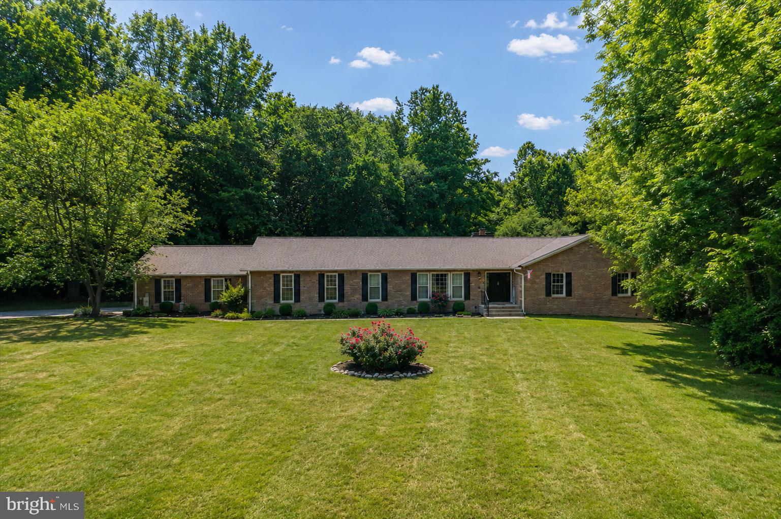 Welcome to 6420 Meadowlark Drive, a spacious 5,888 total square foot home in the prestigious highly sought-after Tall Oaks community. Set on a beautifully landscaped 2.01 acre lot, this home offers the perfect blend of comfort, functionality, and easy one-level living—plus a finished lower level for even more space to relax and entertain.
Step through the large, welcoming double door foyer into an airy main level designed for both everyday living and hosting special occasions. The sun-filled kitchen is a chef’s dream, featuring granite countertops, a center island with range, breakfast bar, and a cozy breakfast room that opens directly to the back deck—ideal for sunset dining. There's ample seating for everyone to connect, dine, and unwind.
The living room is anchored by a striking stone fireplace, while the formal dining room impresses with floor-to-ceiling windows that flood the space with natural light.
A bonus room offers flexible use—perfect as a home office, playroom, or creative studio. The thoughtfully designed layout places the private primary suite on one side of the home, while three additional bedrooms and two full baths are situated on the opposite wing—ideal for privacy and guests.
Function meets style in the side-load two-car garage, which flows seamlessly into a mudroom, then a laundry room, and finally into the kitchen—a perfectly practical route for busy days and everyday convenience.
The lower level is game-day ready with space for a media lounge, pool table, and a bar area—all designed for effortless entertaining. Updates include a new roof, new windows, and new carpet.
Ideally located between Annapolis and Washington, D.C., this home offers easy access to commuter routes while nestled in a tranquil, established community.