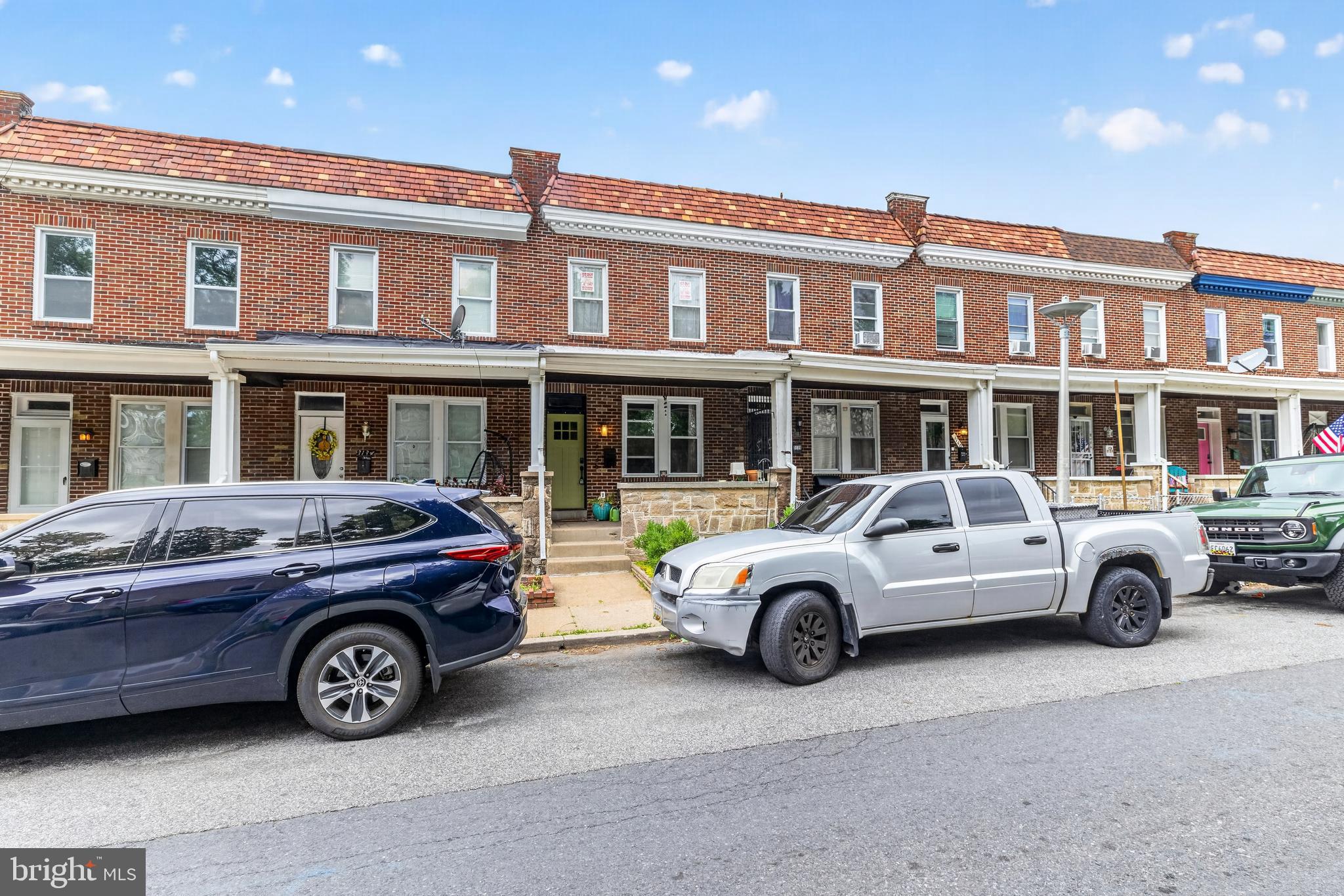 Nestled in the heart of Waverly, this charming rowhome puts you right in the middle of everything that makes living in Baltimore  so special. Tree-lined streets, a tight-knit community, and a neighborhood with genuine personality — this is the one you've been waiting for. 

People-watch and enjoy the atmosphere of this adorable neighborhood from your large front porch. The front yard had just enough space for a cute little garden, already thoughtfully laid out by the current owners. Step inside to a main floor that feels immediately welcoming with an open-plan layout perfect for entertaining and everyday living. The kitchen is fully equipped with an electric range and dishwasher,  flowing right out to a private deck that is the ideal setting for your morning coffee or summer grilling. 

Upstairs you'll find 3 comfortable bedrooms and 1 full bath. The finished basement adds space and versatility to this home: use it for a home office, a rec room, or a guest suite. The second full bath and stacked laundry round out the convenience of this space. Central air and heat throughout keeps every floor comfortable all year round.

Did someone say parking? Yes, this home boasts a single-car garage AND a parking pad out back. Never circle the block again! Live near JHU (just minutes away), the Waverly Y,  a large public library,  a variety of shops, and a thriving dining scene. Enjoy summer within walking distance of the beloved Waverly Farmers Market. Commuters will appreciate quick access to I-83 and other major routes, easy connections to public transit, and a central position that puts you within a short drive or ride of everywhere Baltimore has to offer: the BMA, Sherwood Gardens, Druid Hill Park, Hampden, Charles Village, downtown, and more.

This is Charm City living at its most charming. Come see it for yourself!