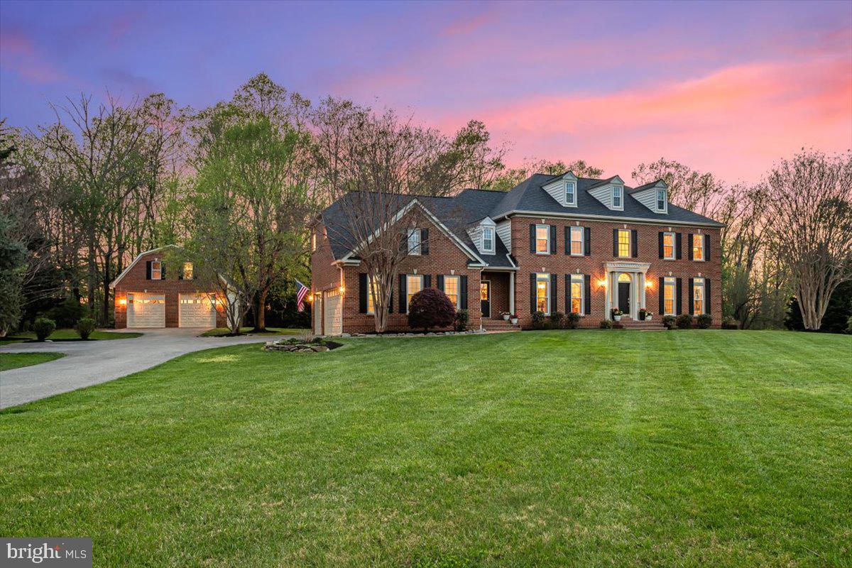 Welcome home to this impressive brick center hall colonial on 2+ acres on a private, manicured cul-de-sac!  Bring your RV or boat- it will fit in the detached garage that is 50 feet deep and has extra high entry doors/high ceilings or have the mechanics/contractors workshop of your dreams, with an unfinished 2nd floor above to create your dream office/suite.  This gracious property exudes elegance and warmth at the same time- a rare combination of breathtaking entertaining spaces and warm, unassuming casual spaces- all bathed in an abundance of natural light.  The main level offers an airy two-story foyer, open living and dining rooms, a powder room, a roomy office, a huge family room centered on a floor-to-ceiling stone fireplace with a two-story ceiling, a generous kitchen with a center island, a walk-in pantry, and a cheerful breakfast room overlooking the updated deck and lawn.  A dual-entry laundry room and entry to the attached three-car garage finish this floor.  Upstairs beckons with double staircases, a cavernous owners’ suite with a walk-in closet, spa bath with soaking tub, dual vanities, and a walk-in shower, 3 additional bedrooms, and two more full baths.  The lower level features a double-door walk-up to the lawn, brand-new luxury plank flooring, a full bath, and tons of storage.  The windows were replaced in 2025 (main house), and a new roof and HVAC system were installed in 2020.   The nearly 50-foot-long detached garage has oversized doors, room for lifts, water and electric, and a staircase to a second floor that awaits your finishing touches.  Store all your cars, toys, or even your pontoon boat (this owner does)- this structure is special!  This turnkey home offers privacy and serenity in a very special pastoral setting- a true forever home!