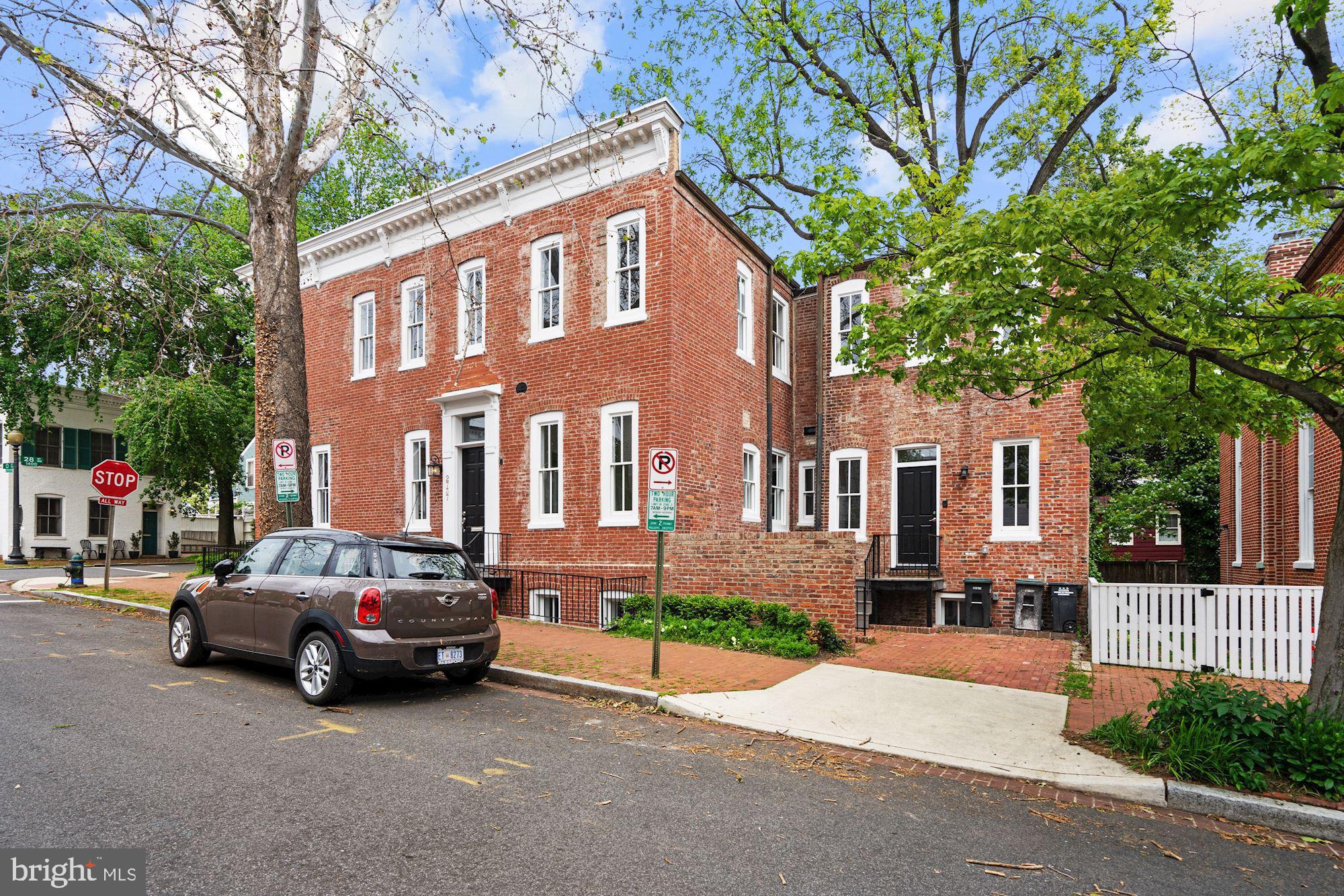 Completely renovated classic Georgetown home featuring 4 Bedrooms, 4 Full Baths and 2 Half Baths with an open floor plan perfect for modern living and gracious entertaining. This stunning home offers a first floor private Office with frosted french doors, a bright and spacious Living Room with Fireplace, a Dining Room with Wet Bar and a Great Room with Coffered Ceiling, Fireplace, Built-ins and original stained glass transom windows. The Gourmet Kitchen includes Stainless Steel Appliances, Marble Countertops, table space and a door leading to the side exterior. The Upper Level features a gorgeous Master Suite with Tray Ceiling, Built-ins, 3 closets, a large Sitting Area and a Master Bath with dual sink and luxurious standing shower. Two additional spacious Bedrooms with En-suite Baths; a Laundry Room and an expansive Work or Sitting Area with skylights complete the upper level. With it s own outside entrance, the Lower Level can be used as additional entertaining space or an In-Law/AuPair Suite that includes a sun-filled Living Area with Fireplace; a full Kitchen with Granite Countertops and Stainless Steel Appliances; a Bedroom with Full Bath; and a Den or Gym with Wet Bar, Half Bath and an additional outside entrance. The brick driveway on the side of the house is perfect for a small vehicle or to store bicycles and other outdoor equipment.