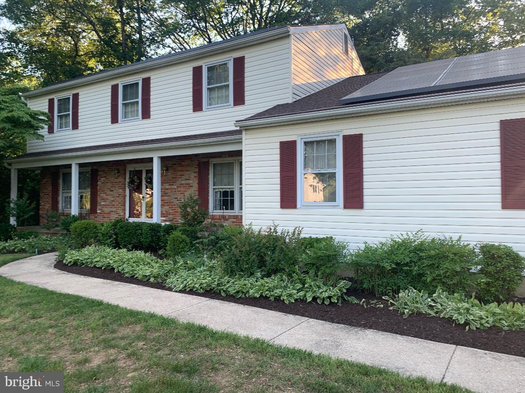 Welcome to this lovely energy-efficient home situated on one of the largest, level lots in the beautiful Chartwell community. This well-cared-for colonial offers the perfect blend of comfort and space. The beautifully planted front yard creates wonderful curb appeal, while the landscaped backyard with a peaceful stream provides a private outdoor retreat perfect for relaxing, entertaining, and creating lasting memories without ever leaving home. The main level features hardwood floors throughout and an updated eat-in kitchen with an island, new cabinetry, countertops, stainless steel appliances, and an open layout designed for everyday living and entertaining. A spacious dining area provides the ideal setting for gatherings and celebrations. Just off the kitchen, you’ll find a cozy family room with a wood-burning fireplace. Upstairs, the spacious primary suite includes an en-suite bathroom. Three additional generously sized bedrooms share the hall bathroom. The lower level expands the home’s versatility with a large recreation room and additional flexible spaces ideal for home office, guest accommodations, fitness or hobby rooms. An expansive dedicated laundry area is also located on this level. The beautifully maintained front and back yards offer plenty of space for outdoor enjoyment, while the long driveway and wide street provide ample parking for guests. Solar panels convey with the property, adding to the home’s energy efficiency and value. Residents enjoy access to both Chartwell Golf and Country Club and St. Andrews Swim & Tennis Club. Conveniently located near Benfield Elementary School and Severna Park Middle School, and just minutes from Kinder Farm Park with its trails, open green space, and farm animals.  By the way, if you think this home feels spacious from the outside, wait until you experience the incredible space inside. With your personal touch, make this wonderful property your next home and a place of recreation.