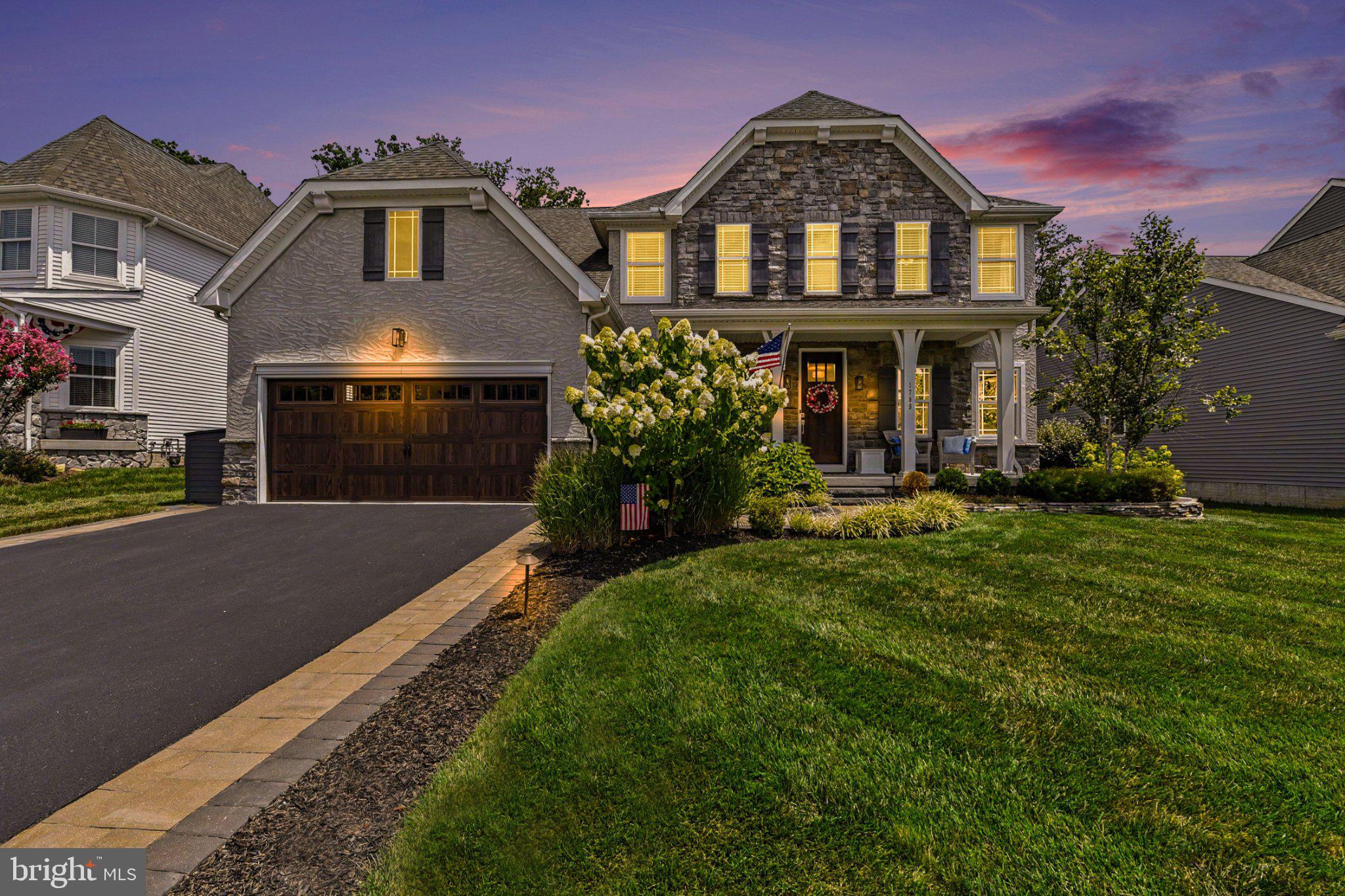 Welcome to this stunning 2019 Keystone custom built home in the sought-after Eva Mar Farms community, perfectly situated on a flat lot that backs to the woods. Beautiful stone and stucco curb appeal, extensive hardscaping, covered front and rear porches, beautifully manicured lawn and professional landscaping deliver a stunning first impression.

Step inside to a welcoming foyer with luxury vinyl plank flooring. To the left, you'll find a beautifully appointed dining room with custom board and batten molding and a private office/den to the right. Straight ahead, the home opens to a light-filled family room, gourmet chef's kitchen, and breakfast nook designed for effortless everyday living and entertaining. The family room features a striking double-sided gas fireplace shared with the rear porch, while the chef's kitchen offers an oversized 8.5' quartz island, farmhouse sink, full tile backsplash, stainless steel appliances, and plenty of cabinetry.

A rare main-level primary suite provides a luxurious retreat with dual walk-in closets and a spa-inspired bath featuring a quartz topped dual vanity, a freestanding soaking tub, and an oversized Roman shower. 

Upstairs, a second primary suite, three more bedrooms - all with walk-in closets - and an additional full bath provides exceptional space for family and guests.

The finished lower level includes a spacious rec room with an egress window offering potential for a future sixth bedroom, a powder room, and a large unfinished storage area ready for a home gym, theater, or workshop.

Enjoy outdoor living year-round on the covered rear porch with a floor-to-ceiling stone fireplace, overhead fan, and peaceful wooded views. Thoughtfully upgraded throughout with custom moldings, designer finishes, luxury flooring, and an ideal Bel Air location, this turnkey home offers the perfect blend of luxury, comfort, and functionality.