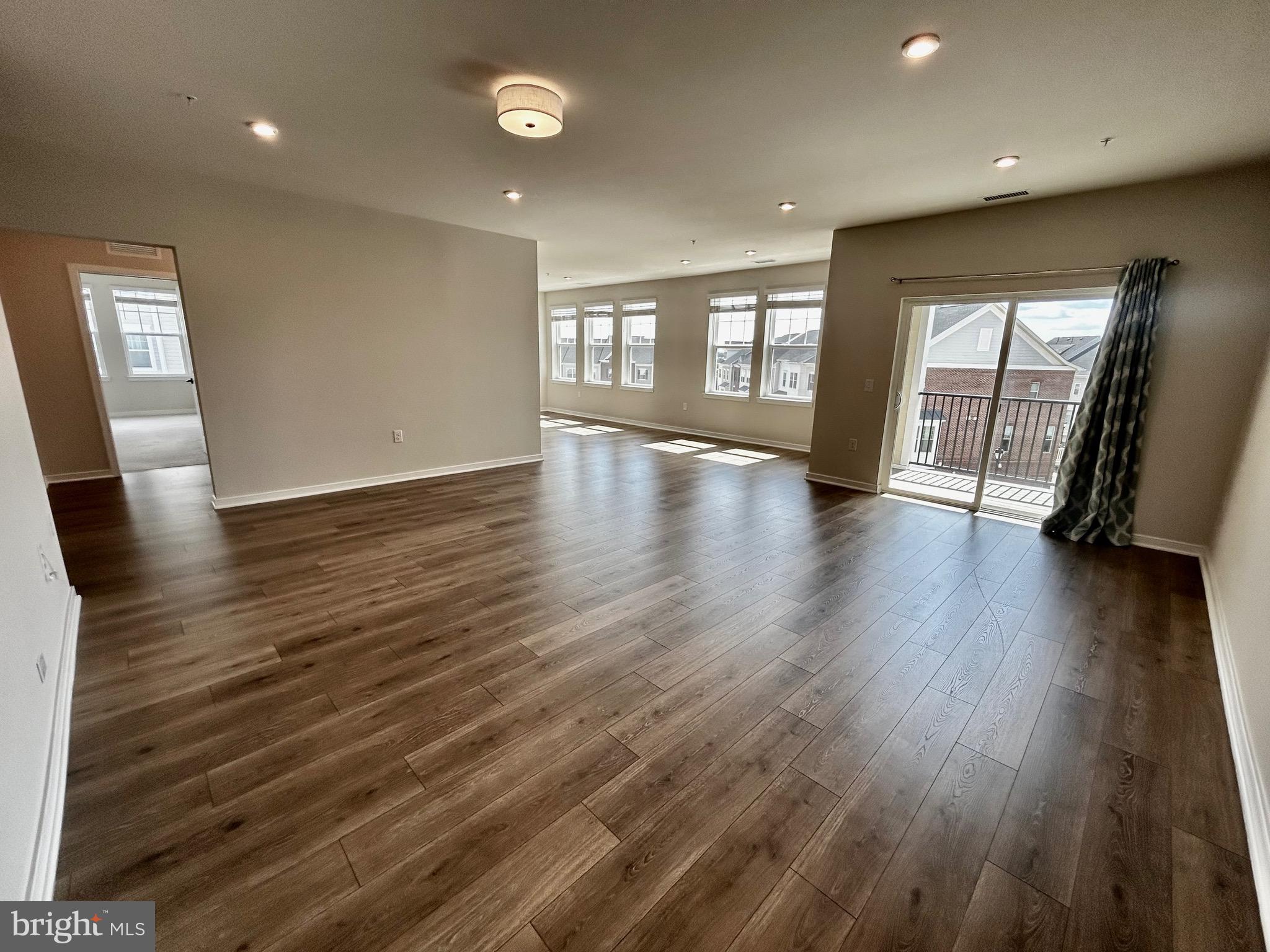 The largest floor plan offering over 1,800 square feet of beautifully designed living space, this exceptional Dogwood model is located in one of the area’s most desirable 55+ luxury communities. Filled with natural light, the home creates an airy, elegant ambiance that feels both sophisticated and inviting.
Every detail has been thought of in showcasing a seamless blend of comfort, style, and high-end finishes. The open-concept layout flows effortlessly, making it ideal for both everyday living and elegant entertaining.
The gourmet kitchen features stainless steel appliances and a custom-designed pantry cabinetry system, combining functionality with refined design with upgraded tile backsplash and counter-tops. The spacious primary suite offers a serene retreat, complete with a custom walk-in closet system and a spa-inspired bath featuring dual vanities, a soaking tub, and a separate walk-in shower.  
A well-appointed second bedroom provides flexibility for guests or a home office and also includes a custom closet system. The 2nd bathroom has a tasteful, with upgraded tile to ceiling in the shower.
Step outside to a private balcony for morning coffee or evening sunsets. Additional highlights include ample guest parking along the main street adjacent to the building, a private one-car garage with secure interior building access. All the windows have upgraded blinds.
Ideally located just a short distance from shopping, dining, and everyday conveniences,  largest corner unit residence offers  low-maintenance  living.
A rare opportunity to experience refined luxury, effortless living, and a vibrant community lifestyle.
