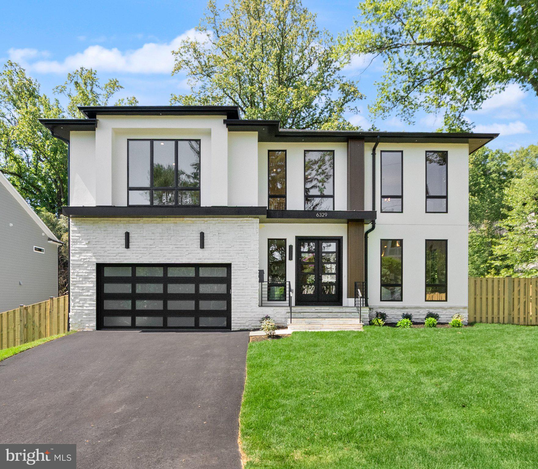Experience elevated modern living in this exceptional newly constructed modern prairie-style residence offering 7,794 finished square feet across three beautifully finished levels and is move-in ready. Thoughtfully designed with refined craftsmanship and contemporary elegance, this home seamlessly blends sophisticated architecture with highly functional everyday living.
Designed to maximize natural light, sight lines, and everyday comfort, the open-concept floor plan features 6 bedrooms, 6 full baths, and 2 half baths. A dramatic two-story foyer, soaring 10-foot ceilings on the main level, expansive Pella Lifestyle black windows and doors, wide-plank engineered hardwood flooring, and designer lighting establish an atmosphere of refined elegance throughout.
The main level is centered around a gourmet chef’s kitchen appointed with premium Thermador appliances, custom cabinetry, quartz waterfall island, walk-in pantry, butler’s pantry, and designer finishes. The adjoining family room, sunroom, covered rear porch, and composite deck create seamless indoor-outdoor living ideal for entertaining and everyday comfort.
The upper level is anchored by an impressive owner’s retreat featuring a private covered balcony, coffee bar, separate custom his-and-her walk-in closets, and a spa-inspired bath complete with heated floors, steam shower, freestanding soaking tub, oversized multi-function shower system, electric towel warmer, and luxury TOTO bidet toilet.
The fully finished walk-up lower level is designed for recreation and relaxation, offering a media room, exercise room, expansive recreation area, guest suite, gas fireplace, powder room, and a stylish wet bar with wine storage. Additional highlights include elevator shaft readiness, an EV-ready garage with dual charging outlets, epoxy garage flooring, pet wash station, advanced smart home wiring system, built-in speakers in selected areas, and security camera prewire.
Perfectly suited on a landscaped lot within the highly sought-after Chesterbrook, Longfellow, and McLean High School pyramid, this remarkable residence presents an exceptional opportunity to own a truly elevated custom home in one of McLean’s most desirable locations.
Green Valley Custom Builders, winner of the 2024 & 2025 NVBIA Best Design & Architecture Detached Home Awards in the $3M–$5M category, is recognized for seamlessly integrating modern design, indoor-outdoor living, and exceptional craftsmanship. Known for seamlessly integrating modern design, indoor-outdoor living, and exceptional craftsmanship, Green Valley Custom Builders pairs refined luxury living with genuine hospitality and support well beyond move-in.