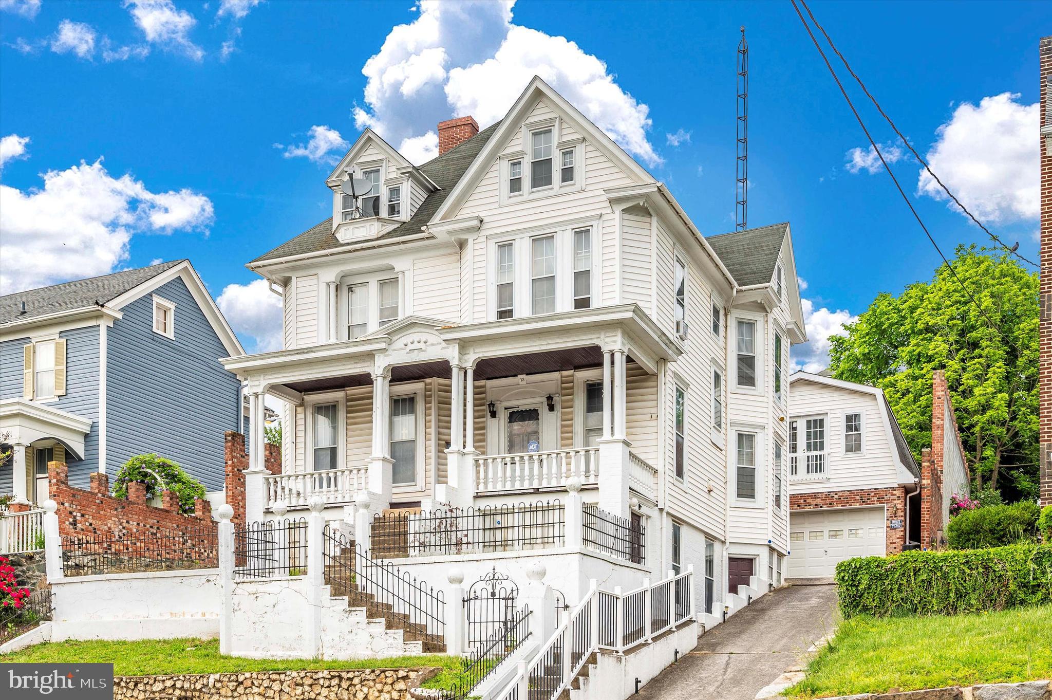 This beautiful 1910 Victorian home has been owned by the same family for the last 50 years and now someone else will have an opportunity to make it their own! One of the best features of this home is the large 2 car garage, perfect for a car enthusiast. Above this 900 square foot garage, you will find a huge unfinished area that has endless possibilities: game room; workshop; office; or possibly just a great hang out space. It also includes a rough- in bathroom. Enjoy your morning coffee or tea from the expansive front porch overlooking the downtown area with a backdrop of the Appalachian Mountains. Inside, this home boasts character in its original state to include: several built in bookshelves; a grand solid wood staircase; wainscotting; all wooden doors; second staircase; and extravagant woodworking. Put your finishing touches on this home by uncovering the hidden hardwood flooring throughout. Make the fully finished third level a playroom, bedroom, office, or guest room. Work your way to the unfinished basement where plenty of storage can be found. One section of this lower level once housed a beauty salon! Have peace of mind with the newer furnace. Enjoy entertaining in your extremely private, brick fenced back yard. Enjoy nature? This is only a hop, skip, and a jump from the C&O Canal, the Potomac River, and historical Harpers Ferry. Great commuter location with close proximity to the MARC train, Northern Virginia, and West Virginia. Look past the wallpaper and the carpeting and imagine turning this historic home into the home of your dreams!