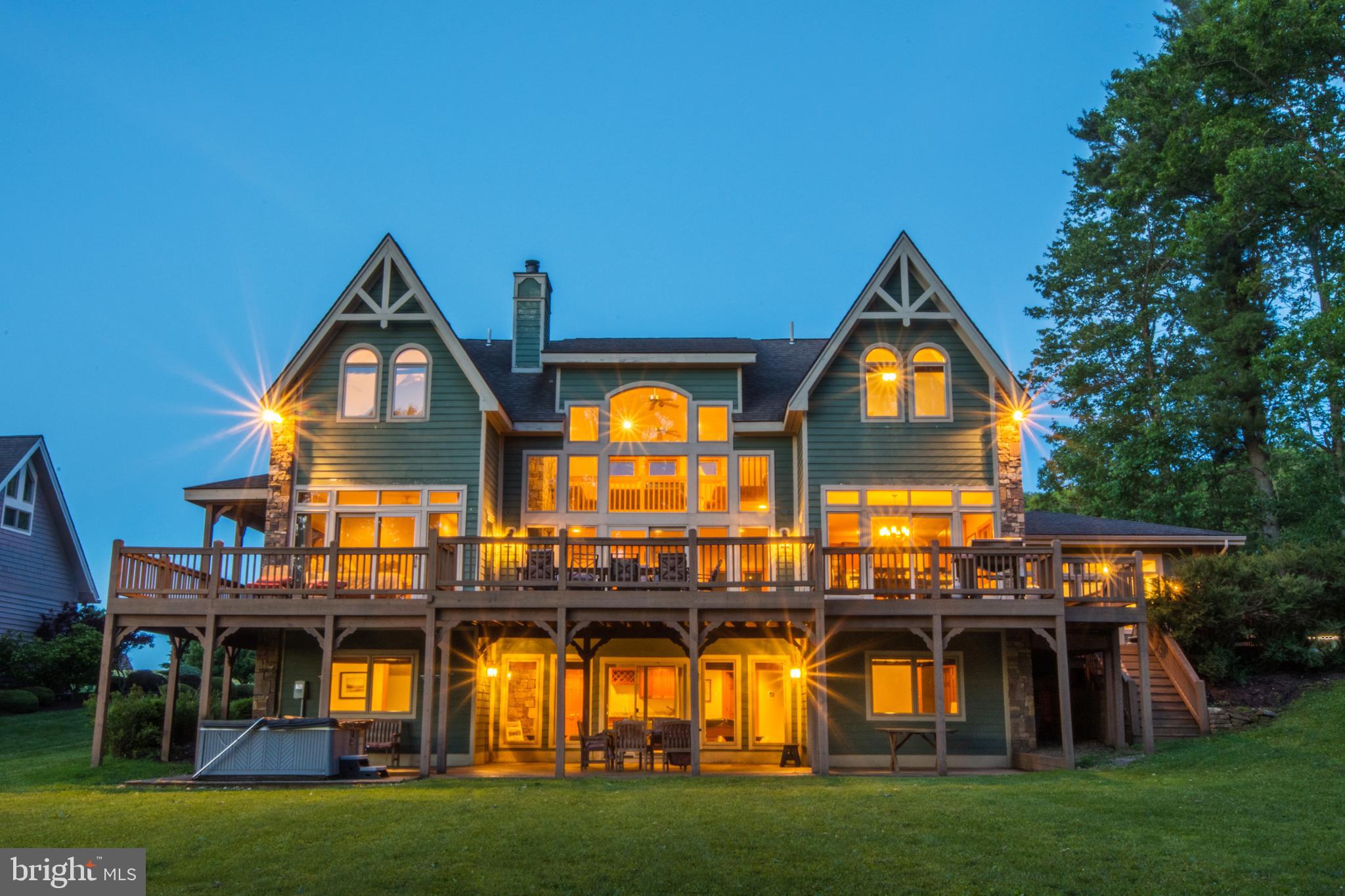 'Unforgettable' is one of the highest grossing vacation rentals you will find at Deep Creek Lake - annual income averaging $250k over the past few years. It is the perfect culmination of choice waterfront (western exposure & low traffic cove), custom floor plan & design, attention to detail and a master planned vacation retreat. Boasting 5000sf , 8BRs, 8.5BA with a boat slip, additional slip for PWC/wave runner, indoor pool + sauna, multiple hot tubs and a maximum occupancy of 26 people - rare grandfathered status. This custom built masterpiece is an iconic lakefront property with an elite lakefront lot. Impressive & rare building lot where you are so close to the water you can keep an eye on your boat and be mesmerized by the expansive lawn and colorful sunsets, all with the water always in view. 6 spacious suites, multiple fireplaces and a unique floorplan with plenty of privacy coupled with an expansive wraparound deck and a lakeside fire pit on a 131ft+ dream lot make this the perfect combination, especially when you factor in the amenities at Waterfront Greens. A par-3 golf course, catch and release fishing pond, tennis courts, mini-golf and neighborhood sledding hill in colder months. This quiet & prestigious community is also ideal for taking your morning stroll or riding bikes on quiet streets without fear of normal road traffic. Pride of ownership is evident throughout. New roof in 2023, updated bathrooms, updated flooring and constant tweaking of furnishings, contents & amenities have been vital to the long term success and legacy of this one-of-a-kind waterfront home! All future rental income can be yours, as well as being sold TURN-KEY. Shown by appointment and only on days between rentals.