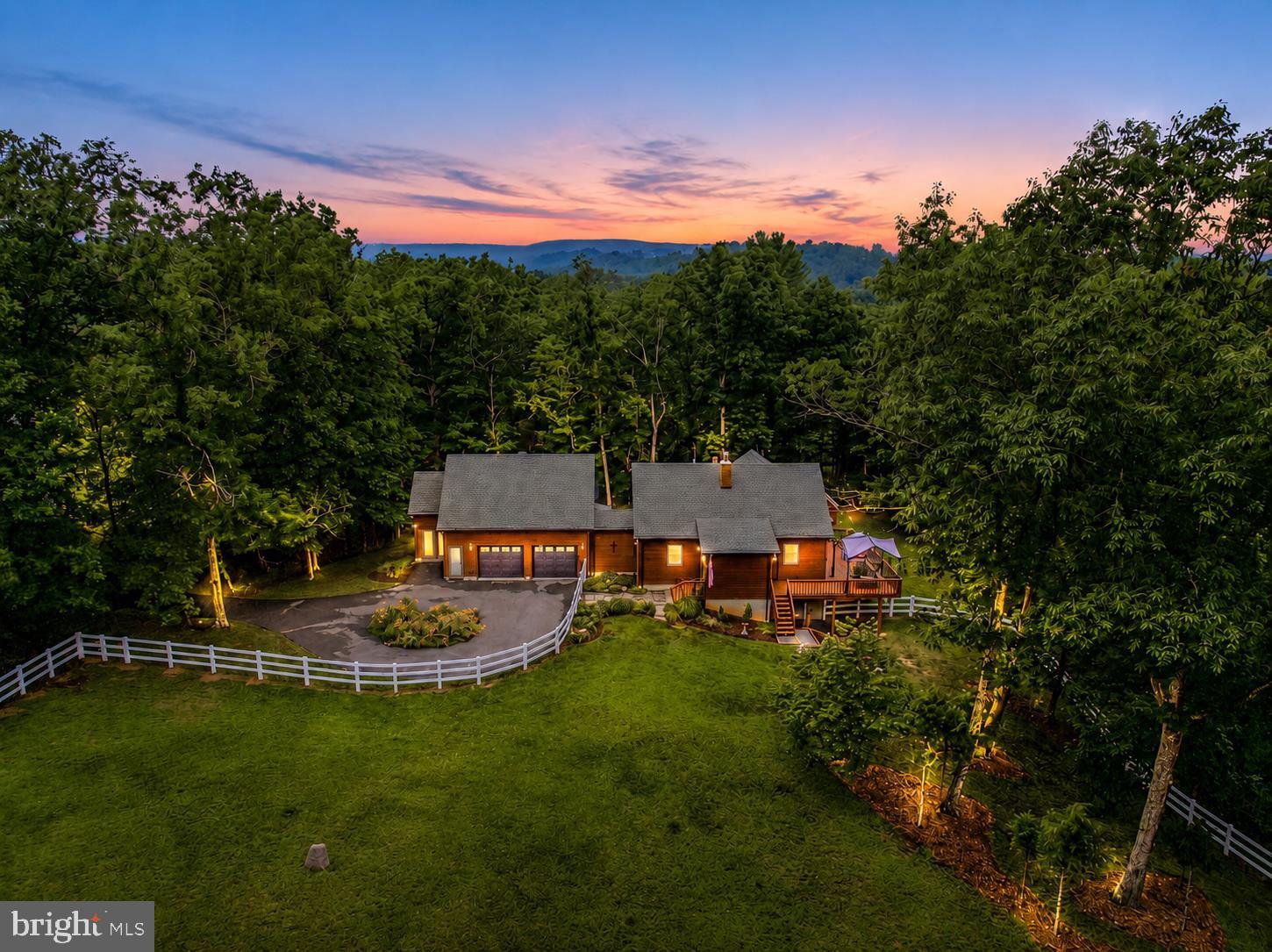 THIS HOME HAS IT ALL!  Beautiful cedar-sided home nestled on 6.55 private acres (2 lots), offering the perfect blend of privacy, comfort, and modern conveniences. Featuring 3 bedrooms and 3 full baths this spacious home is designed for both everyday living and entertaining.  The open-concept kitchen, dining, and living area flow into a large family room, creating an inviting space for family gatherings. French doors lead to an expansive deck where you can relax and enjoy the peaceful surroundings.  Stay comfortable year-round with two gas fireplaces and a wood stove. The fully finished walkout basement features a recreation room, office, full bath, and laundry area with a stackable washer and dryer, making it ideal for guests, hobbies, or working from home.  Large windows fill the home with natural light. Additional features include beautiful hardwood floors, heated tile floors, a pantry, cedar closet, abundant storage, tankless hot water heater, and fiber-optic high-speed internet, making this home - work-from-home ready. The oversized two-car garage includes attic access for even more storage.  The property is partially fenced for pets and offers plenty of room to enjoy the outdoors. Located just minutes from historic downtown Berkeley Springs and public access to Sleepy Creek, you’ll enjoy the convenience of nearby shopping, dining, outdoor recreation, and all the charm that Berkeley Springs has to offer.  A rare opportunity to own a private retreat with modern amenities, spacious living, and an unbeatable location!