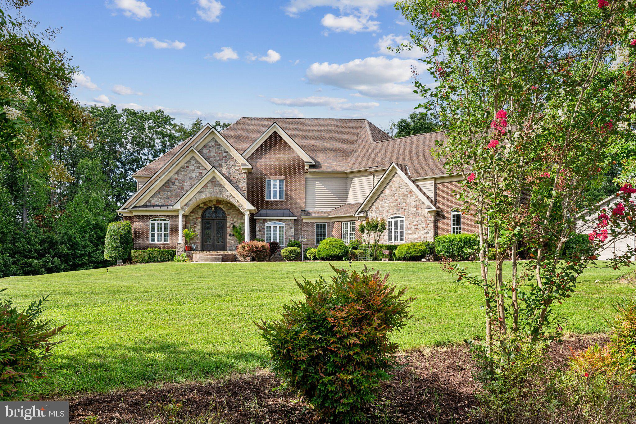 Discover unparalleled luxury and comfort in this exquisite custom-built estate home, thoughtfully designed for multi-generational living and ultimate convenience. Nestled on over 3 acres of pristine land, this masterpiece offers over 11,500 square feet of finished living space, featuring a three-stop interior **elevator** for seamless accessibility, a newly added **gorgeous in-law suite** complete with a large bedroom and stylish full bath, and expansive living areas perfect for accommodating extended family and guests. Every detail of this home exudes sophistication, from the stunning hardwood floors and intricate iron railings to the high ceilings adorned with custom moldings and extensive woodworking.

As you enter through the grand two-story foyer, you're greeted by a graceful curved staircase and an ambiance of refined elegance. The gourmet kitchen is a chef's dream, boasting high-end stainless steel appliances including a double wall oven, 6-burner gas cooktop, commercial-grade oversized refrigerator, and pot filler. Quartz countertops, a large island, and a butler’s pantry with a beverage refrigerator make this space perfect for both everyday living and entertaining. The two-story great room centers around a cozy fireplace, while the adjacent sunroom floods the home with natural light. For more intimate gatherings, the formal dining room offers a sophisticated setting with its arched doorways and detailed craftsmanship, and the study provides a peaceful retreat with built-in bookcases.

The main-level master retreat serves as a private sanctuary, featuring a sitting room with its own fireplace, a luxurious bath with a jetted tub and spacious shower, and a generous walk-in closet. Ascend the back staircase to discover a grand family room or loft area with open archways, along with expansive upper-level bedrooms each offering sitting rooms and en-suite baths for unparalleled privacy and comfort.

The lower level is an entertainer's paradise, complete with a recreation area, media/theater room, exercise room, and a fully equipped second kitchen. The standout **in-law suite** adds to the home's versatility, ideal for accommodating guests or extended family with its own tankless electric hot water heater ensuring comfort and independence.

Outside, the estate continues to impress with a stone patio, extensive landscaping, a shed, greenhouse, outdoor fireplace, and even a chicken coop with a large run. Car enthusiasts will appreciate the 4-car side-load garage and the newly added 12-car detached garage, featuring separate electrical service, airlines for compressors, a spacious storage loft, smart LED lighting, and multiple electrical circuits ranging from 15 to 50 amps.

Additional features include three heating and air units, a 500-gallon underground propane tank, smart switches for exterior and select interior lighting, an external generator connection, upgraded garage doors with smartphone capability, and refinished garage floors and walls. The home's location offers the perfect blend of privacy and convenience, situated in a prestigious neighborhood close to top-rated schools, major routes like Rt. 17 and I-95, and amenities such as Curtis Park, The Gauntlet Golf Course, and Hartwood Winery. Easy access to Warrenton and Manassas ensures you're never far from shopping, dining, and entertainment options.

This extraordinary estate is more than just a home—it’s a lifestyle of unmatched luxury and sophistication. Schedule your private showing today and experience the exceptional living that awaits you.