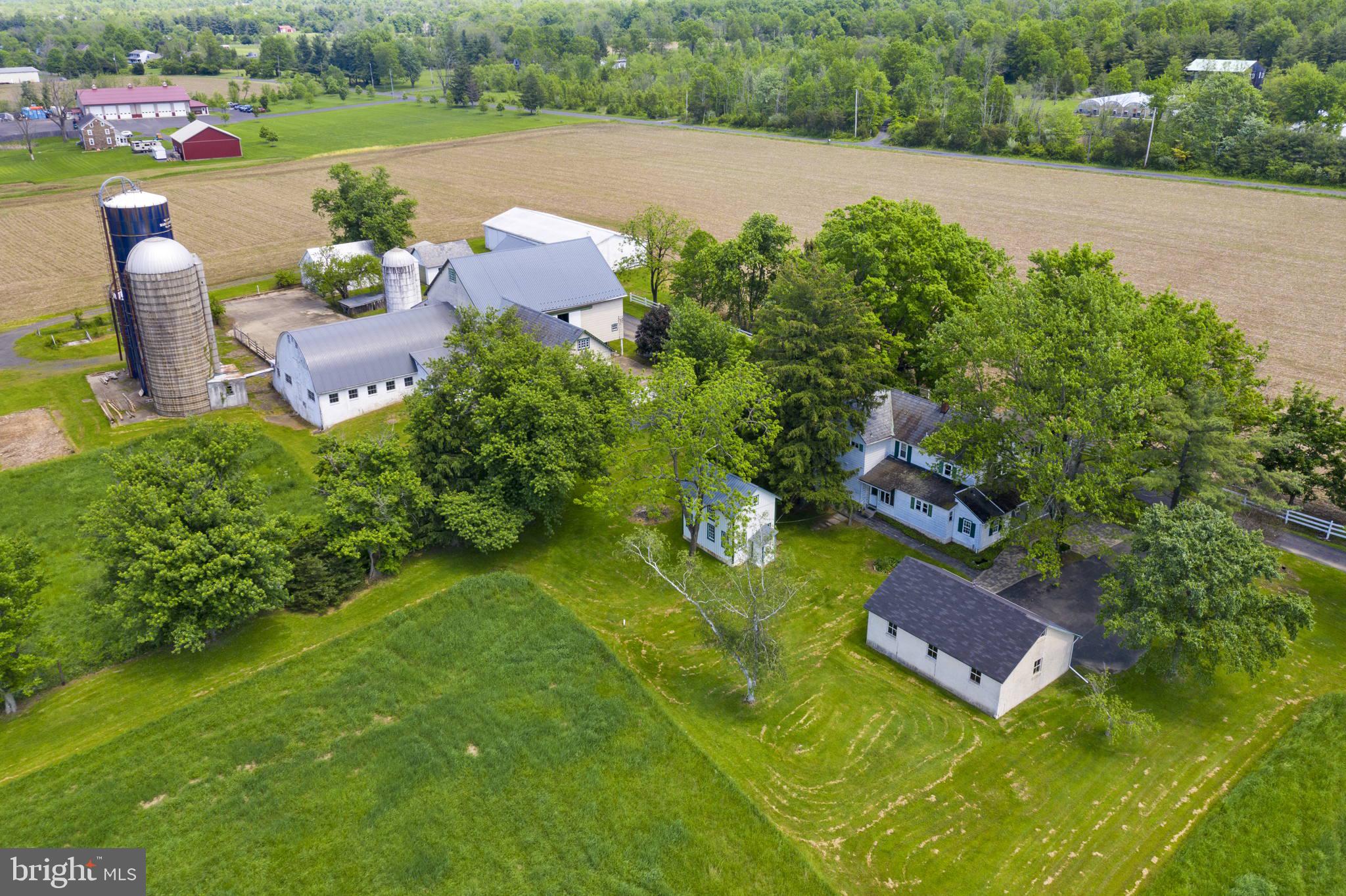 103 acres of beautiful Bucks County farmland!  This picturesque working farm has been in the same family for generations and is now ready to become a new family's homestead.  Property consists of two parcels - Tract 1 is 61 acres with the farmhouse, barn and outbuildings and Tract 2 is 41.9 acres of vacant land.  Both parcels are under a conservation easement.  However, approximately 6 acres of  Tract 1, with frontage along Old Easton Road, is not under the easement and offers subdivision potential.  The easement also allows for one additional house to be built on a two acre envelope.  New house could be built on either parcel.  Serene location with the farmhouse and barn set well off the road down a tree line drive.  The farmhouse offers historic character with many original doors, built-in cabinets and wood trim.  The house is currently set up for two families with two full kitchens, two staircases and two full baths.  However, the home is not formally divided and easily can be used as a single family residence.  Next to the house is a three car detached garage with newer roof plus a large garden shed that also could be used for storage, workshop,  or as a chicken coop.   The farm buildings include the large bank barn complex that has a new roof over the addition and was previously used as a dairy.  In addition there is a large machine shed, several silos and additional outbuildings that would be ideal for a multitude of uses.  However, the highlight of the farm is the land.  With over 100 acres of gently rolling countryside offering tillable acres and lush pastures, the possibilities are truly endless!  Please do not go down driveway without an appointment.