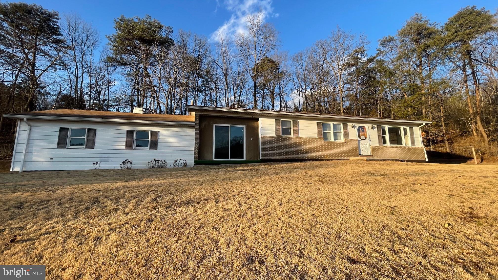 CALL NOW TO SEE THIS ONE LEVEL BRICK AND VINYL SIDING RANCH STYLE HOME ON 1.77 ROLLING AND WOODED ACRES NEAR THE COUNTY LINE BETWEEN HAMPSHIRE AND HARDY COUNTIES.
THE HOME HAS THREE BEDROOMS, ONE BATHROOM, LIVING ROOM , KITCHEN, DEN AND TWO CAR GARAGE. STORAGE SPACE IS AVAILABLE IN TWO SHEDS. IF YOU ARE LOOKING FOR A STURDY HOME WITH NOTHING BUT WILDLIFE AND PEACE AND QUIET THEN THIS IS FOR YOU.  ENJOY THE WILDLIFE INCLUDING DEER, TURKEY, SQUIRRELS AND OTHER CRITTERS. BE A STAR GAZER AS YOU SEE CONSTELLATIONS, MOON, SATELLITES AND PLANES. MOVE  TO WEST VIRGINIA AND BECOME A MOUNTAINEER.