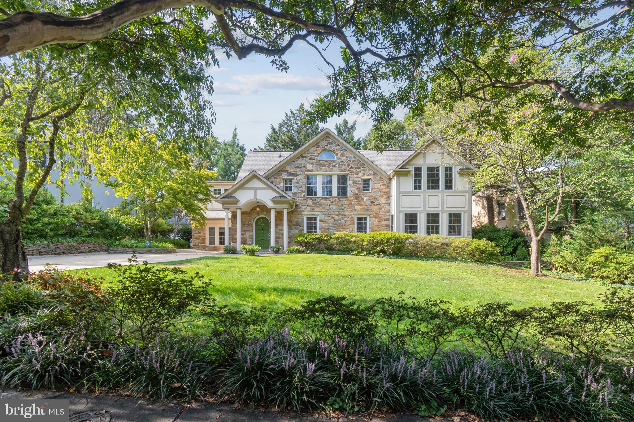 This is indeed a special one! Nestled amongst some of the most distinguished and exceptional residences in Town of Chevy Chase, this beautiful home is located on one of the prettiest streets in Town, Meadow Lane.  This exceptionally rare stone residence was built in 1929 and thoughtfully renovated & expanded in 2002. Entering the home, there's a dramatic wide-arched staircase and an impressive stone fireplace to greet you! The main level is open and beautifully lit with natural light from its highly desirable southeast exposure. This level also has a spacious living room, formal dining, family room featuring stone walls, a rare bedroom suite with full bath for your guests and an incredibly desirable home office space tucked away from the main living area for complete privacy.  There's a brand new kitchen complete with Woodmode cabinets, Thermador appliances, quartzite counter tops, an expansive island and additional space for a kitchen table. The second floor has 4 bedrooms and 3 bathrooms, an open space for a reading area or play room and  washer & dryer. There is extra storage in the basement cellar and an attic space.
The grand front yard affords plenty of privacy and a long driveway provides a lot of off-street parking.
The cozy backyard features a stone patio complete with a custom-built fire pit; what a perfect place for an enchanting evening under the stars! 
Meadow lane is in the heart of Town of Chevy Chase, insulated from busy road noise yet still a scenic, leisurely stroll from the many gourmet restaurants of downtown Bethesda and there's very easy access to the Redline metro station. This location is the perfect choice for those who desire a truly gorgeous neighborhood complete with comprehensive resident services (like no other!) and with all of the conveniences of the city right at hand. Don't miss this perfect opportunity.