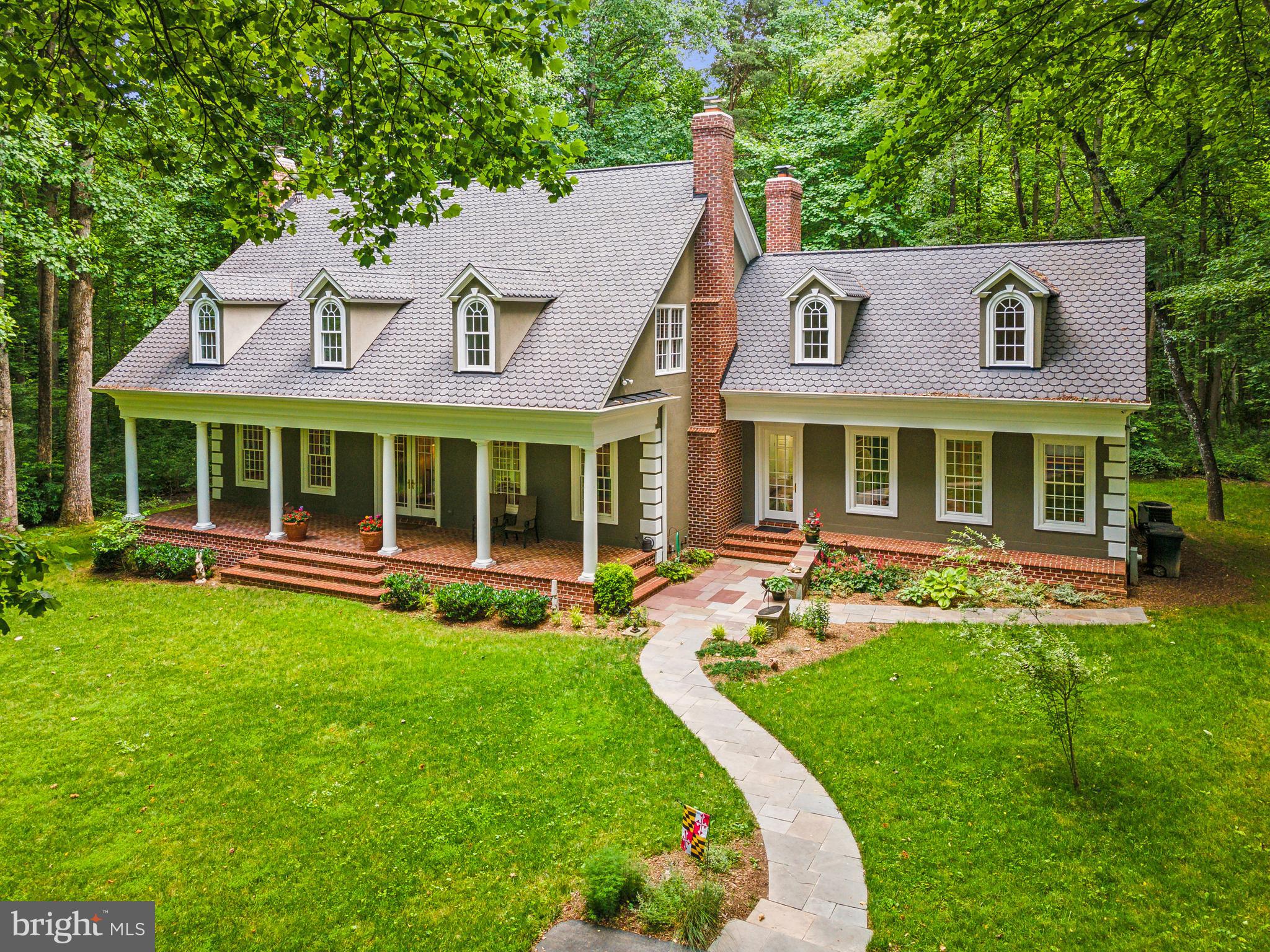 Welcome to 8683 Reservoir Road, where elegance meets tranquility in this stunning 5-bedroom, 4.5-bathroom retreat nestled on a serene 3-acre wooded lot.

As you enter, you'll be greeted by the charm of a classic front porch, inviting you to step inside and discover the warmth and comfort this home offers. The main level boasts a luxurious, renovated primary bedroom suite, providing convenience and privacy, along with an updated primary bath for a touch of modern sophistication.

Entertaining is a delight in the spacious kitchen featuring Ubatuba granite countertops, ample cabinet space, and a surplus of counter space, making meal preparation a breeze. The kitchen seamlessly flows into the living areas adorned with red oak hardwood floors and illuminated by natural light streaming through Pella windows and doors.

Cozy up by one of the three fireplaces on chilly evenings or step outside onto the stone patio at the back of the house, where you can unwind with a glass of wine or host memorable cookouts with friends against the backdrop of nature's beauty. The lush greenery surrounding the property provides a picturesque setting, ideal for nature lovers and birdwatchers.

With over 4000 finished square feet and an additional 3000 square feet of unfinished space in the basement, there's plenty of room for customization and expansion to suit your lifestyle needs. The attic is spacious and perfect for additional storage. Plus, the 50-year architectural roof ensures lasting durability and peace of mind.

Don't miss this rare opportunity to own a piece of paradise in a coveted location. Come experience the allure of 8683 Reservoir Road and make it your own haven for years to come. Schedule your showing today!