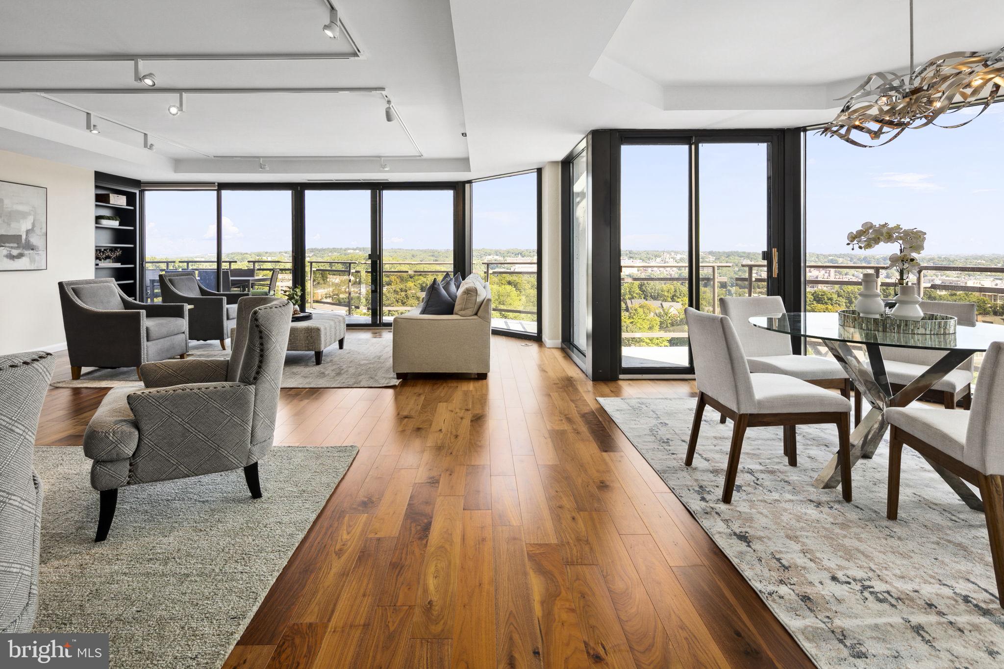 This is unit 1112 and 1115 combined. Step into this stunning, reimagined condominium at the Atrium Residences. Spanning 2,785 sq. ft., this expansive corner-unit home offers a seamless blend of modern design and breathtaking views that define upscale living. Bask in the sweeping, unobstructed views of the National Cathedral, Georgetown University, and the Key Bridge, while enjoying the beauty of sunrises and sunsets from any of the five magnificent balconies. The open living room, designed with floor-to-ceiling glass walls, welcomes natural light and showcases spectacular cityscapes, making the space perfect for both entertaining and serene relaxation. A family room is the perfect spot for a television and reading with a wall of custom built-ins. The state-of-the-art kitchen features high-end appliances and custom cabinetry and has pass through openings to the dining room creating a chef’s dream. The condo offers a thoughtfully designed floorplan, including a first bedroom/office facing east for inspiring sunrises, and third and fourth bedrooms or den spaces nestled in the north/west corridor for tranquil evenings. The master suite serves as a private retreat with expansive views, a dressing room, and an elegant ensuite bathroom equipped with premium fixtures and finishes. The custom designed butler’s pantry includes two temperature-controlled wine coolers, glass cabinetry for stemware and loads of storage.  A laundry room to die for has been outfitted with cabinetry and countertops, drying racks, a tv and beverage refrigerator. This property has ample storage in unit and includes two additional storage units on the main level of the building. The residents of this home enjoy access to exclusive amenities, including a fitness center, pool, tennis and pickleball courts, a dry cleaner, 24-hour concierge services, and three secure parking spaces. Situated in Rosslyn Heights, looking down on Rosslyn, the condominium offers easy access to dining, shopping, and cultural attractions, while maintaining a serene, private environment.