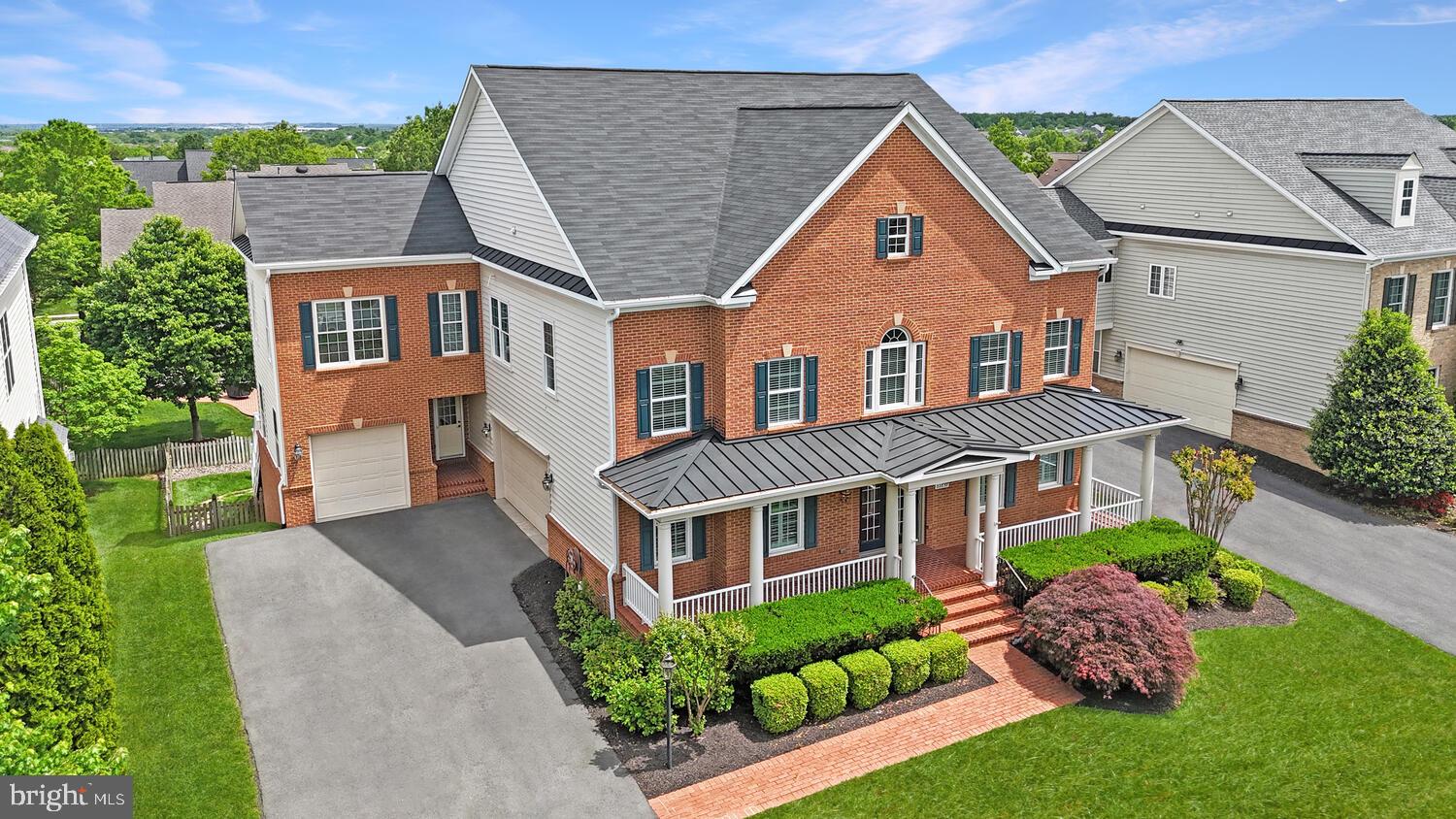 Effortless Luxury Living with Exceptional Space and Multi-Generational Design.
<br><br>
This stately all-brick colonial offers over 7,000 square feet of refined living on a lush ⅓-acre lot. Featuring six bedrooms and four-and-a-half baths, the home is exceptionally well suited for multi-generational living, with private guest or in-law suites on both the upper and lower levels and a high-capacity residential elevator providing convenient access to all floors.
<br><br>
Gracious interiors showcase newly hand-finished hardwood floors, custom moldings, and an easy, flowing layout ideal for everyday living and entertaining. The formal living and dining rooms offer elegant, well-defined spaces perfect for holidays and special gatherings, with a tray ceiling adding architectural interest to the dining room. The sunlit family room centers around a cozy gas fireplace, while a private main-level office provides a quiet work-from-home retreat.
<br><br>
The chef’s kitchen is a true showpiece, designed for both everyday living and effortless entertaining. Quartz countertops, shaker-style cabinetry, and a timeless subway tile backsplash frame a massive center island with generous seating, making it the natural gathering place of the home. High-end KitchenAid stainless steel appliances—including a gas cooktop and double wall oven—deliver exceptional performance, while designer pendant lighting adds warmth, depth, and a refined finishing touch.
<br><br>
The luxurious primary suite is a true sanctuary, offering a private balcony, tray ceiling, hardwood floors, step-down sitting room, expansive walk-in closet, wet bar, and a spa-inspired bathroom with soaking tub and walk-in shower.  Secondary bedrooms are generously sized and thoughtfully arranged, including a Jack-and-Jill layout. A second upper-level office and spacious laundry room complete the upper floor, all easily accessible via elevator.
<br><br>
The daylight walk-out basement expands the living space with LVP flooring, a second gas fireplace, a custom home theatre, a full bath, and a sixth bedroom—ideal for extended family or guests.  Ample storage includes a large room with built-in shelving.
<br><br>
Outdoor living features an expansive deck with stairs to a fully fenced and landscaped backyard. An oversized three-car garage with a separate entrance adds everyday convenience.
<br><br>
The home has benefited from over $50,000 in recent renovations, including all hardwood floors newly hand-finished and newly remodeled bathrooms in both the upper- and lower-level guest suites.  Additional improvements include a high-capacity residential elevator serving all levels, a whole-house generator for uninterrupted comfort, and a zoned fire suppression system that has been recently inspected and is in excellent working condition.
<br><br>
Located in the highly desirable Brambleton community, residents enjoy five pools, over 18 miles of trails, parks, sports courts, and year-round events. HOA includes Verizon FiOS internet and TV. Close to the Silver Line Metro, major commuter routes, and Brambleton Town Center’s shopping, dining, and entertainment—offering the perfect blend of luxury, comfort, and long-term flexibility.