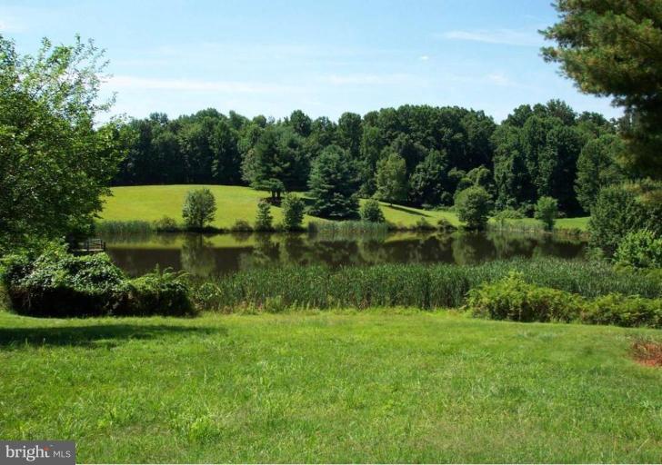 One of the last opportunities to buy and build in the exclusive enclave of estates at The Pond of Beach Mill. 5 of the most spectacular acres in Great Falls, with amazing unobstructed views across the pond, are available for your multi-million dollar estate.   The entrance is graced by an elegant stone and gated entryway. Adjacent 5 acre parcel is also available for purchase.