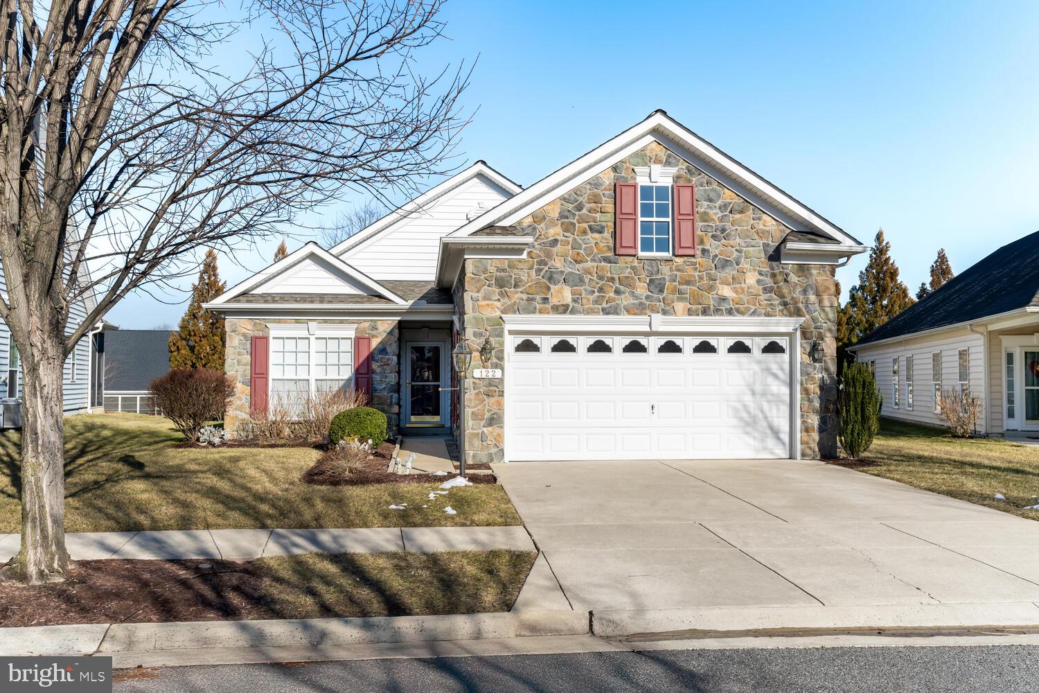 This beautiful Bach model home starts with a stone front exterior and a relaxing rear patio for outdoor enjoyment.  As you enter this true 3 bedroom, 2 full bath home that includes a front office (not counted as a bedroom) you'll be welcomed in with hardwood flooring leading past the formal dining room.  To the right as you enter, you'll find the main level laundry room with a pass through to the garage which includes a Sky Basement above and an interior TV antenna to get local channels.
Moving through the home, you'll find 2 bedrooms along with a full bath and coat closet.  The Gourmet Kitchen features a built in microwave, cooktop, double wall ovens, dishwasher, refrigerator and the kitchen island with Corriann counters.  Your eyes will be immediately drawn to the rear feature wall and the floor to ceiling stone gas fireplace.  The family room also includes plantation shutters and woven wood shades compliment the bedroom.  Of course you'll want to tour the Master Suite with the 2 walk-in closets and addition bump out.  The specially designed Master Bath features split vanity sinks, a large walk-in shower and a enclosed commode. 
This exceptional home also includes many upgrades starting from the time it was built adding Weather Smart House Wrap for temperature control, New Architectural Roof 2024, Tankless Water Heater, New 16 Ser HVAC 2022, UV Dust Filter on Furnace, Rear Irrigation System, Water Spigot in Garage and a Propane Line for a Patio Gas Grill.