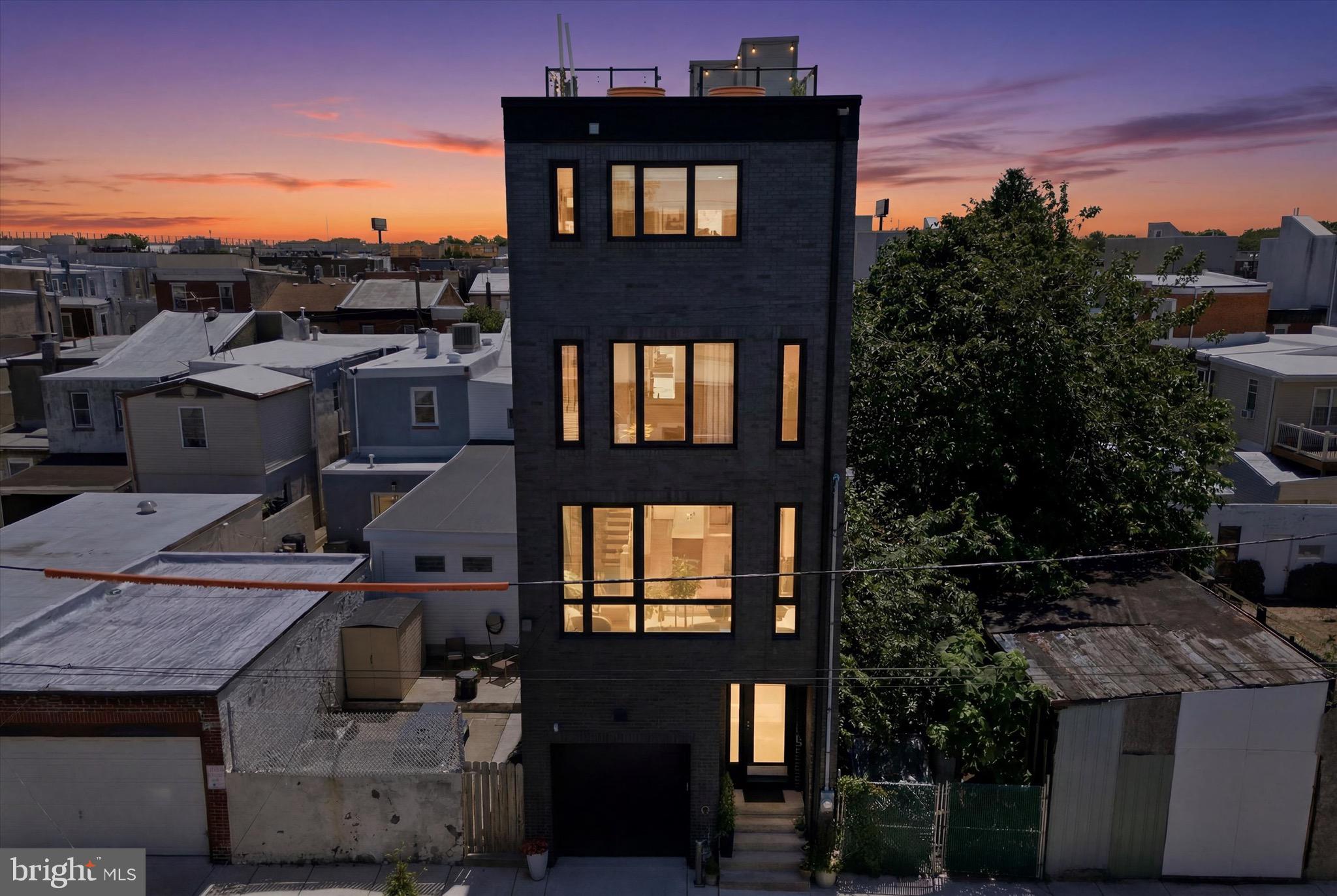 Welcome to "The Cloudline Residence", a striking newer construction home in Olde Richmond/Fishtown, defined by a rare City-approved height variance allowing it to rise above neighboring homes, delivering sweeping, unobstructed skyline views from Center City to the bridges and across the river to New Jersey. The perspective is dramatic, elevated, and truly unmatched.
Built in 2021 by Alexander Sharpan, VP of Construction at Post Brothers, this 3 bedroom, 3 full and 2 half bath home offers approximately 2,293 square feet of refined living, paired with the everyday ease of a 1-car attached garage, opportunity for  electric vehicle charging, and the notable convenience of easy street parking.
A gallery-style entry with soaring ceilings creates an immediate sense of arrival, leading to a flexible den with powder room and rear yard access, ideal for entertaining, work-from-home, or additional living space. The main level showcases a beautifully scaled living and dining area anchored by a custom kitchen with quartz countertops, dual-tone cabinetry, Bertazzoni appliances, oversized Blanco sink, and a discreet butler’s pantry. A private balcony, pre-plumbed for gas grilling, extends the living space outdoors.
The next level features two spacious en-suite bedrooms and a centrally located laundry area. The entire upper level is dedicated to the primary suite, offering a true retreat with a large walk-in closet and a spa-inspired bath complete with imported Italian finishes, Hansgrohe AXOR fixtures, Toto toilets, soaking tub, and walk-in shower.
Crowning the home, the expansive roof deck captures panoramic skyline views and offers a front-row seat to summer fireworks, creating an experience that feels both elevated and unforgettable.
Perfectly positioned near neighborhood favorites including Stock's Bakery, Tacconelli's Pizzeria, Little Susie's Coffee & Pie, Meetinghouse, and Smalls Provisions, with easy access to grocery shopping at Fishtown Crossing and close proximity to the future expansion of The Rail Park, a transformative city investment expected to further enhance connectivity and long-term neighborhood appeal.
A rare offering where design, scale, location, and irreplaceable views converge. The Cloudline Residence stands apart.