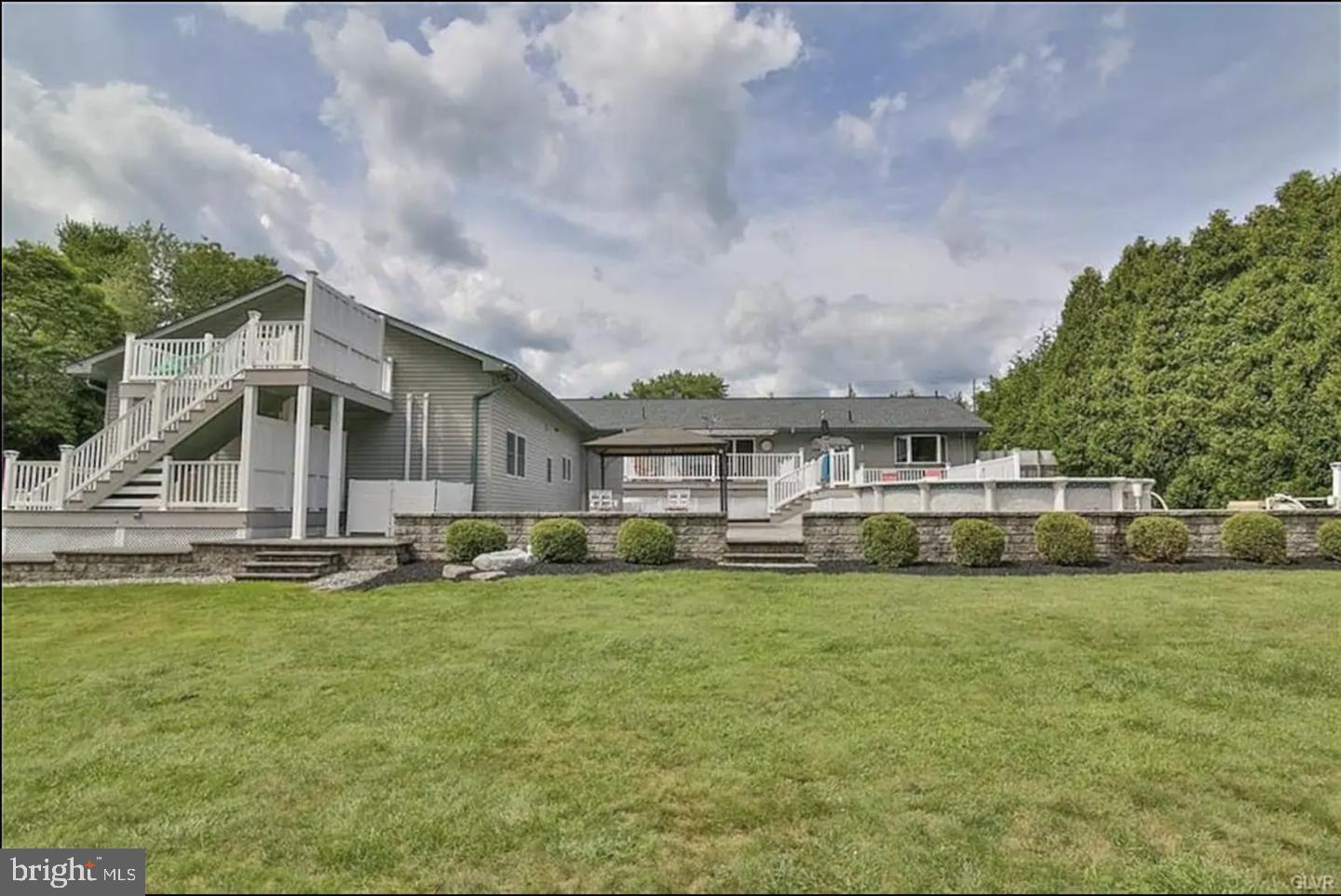 The opportunity to own your very own oasis is here! Presented here is the perfect family home which features a main home, separate apartment and In law suite all in one. The main home has 3 bedrooms and 2 bathrooms. When you walk into the main home you will notice the open floor concept with beautiful Brazilian Teak hardwood floors, natural lighting throughout, solid wood trim windows and doors. The main living room, dining room, kitchen with center island, farmhouse sink and butlers pantry are all designed and finished with thoughtful touches and fixtures. Through the dining room sliding glass door you can access the patio which leads to a fenced backyard with an above ground pool, outdoor lounging area, and a barbecue grill. This level also has the master bed and bath, 2 bedrooms with walk in closets and another full bathroom and full laundry. Moving on down to the basement will not disappoint. The basement has a large siting area, air hockey table, ping pong table, foosball table, gym and theatre room. There are also a few extra rooms for storage and utility. 

The Upper Level Apartment Unit: - The upper-level apartment unit features a living room, bathroom and a bedroom and numerous sky lights to allow natural lighting. 

The in-law suite has its own separate entrance. The in-law suite features a living room, kitchen, 2 bedrooms and 2 bathrooms. The entire in-law suite has been renovated in the past year with costs over $100,000. Updated with new flooring, cabinets, finishes, fans, plumbing, electric, and fixtures. 

We are still not done! This property sits on over an acre of land. Driving up you notice the large driveway which easily fits 8 cars and another 2 car garage. This home features paver patio walkways, multi-level composite wood decking with white vinyl railings, lounge area, above ground pool with deck, outdoor kitchen area with covering canopy, outdoor pavilion, stone walls, and 2 sheds. There is so much that can be done such as expanded outdoor kitchen, dedicated stone fireplace area, playground and the list goes on! To sum this beautiful home and property up is that this could be your own families oasis. Schedule your showing before it’s too late!