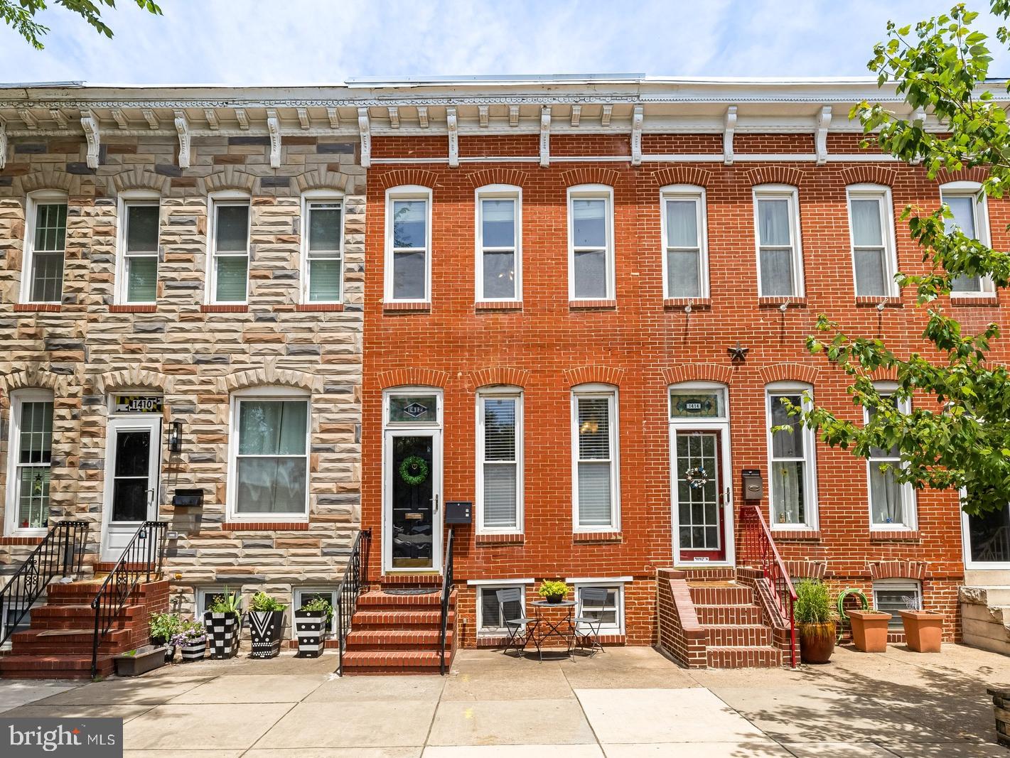 Looking for spacious living in the heart of Locust Point? Welcome to 1412 Fort Avenue! This beautifully maintained home offers generous living spaces, thoughtful updates, and plenty of versatility.
Step inside to a bright and inviting living room featuring gleaming hardwood floors and abundant natural light. The open layout flows seamlessly into the spacious dining area, providing ample room for a large dining set and effortless entertaining. The well-appointed kitchen boasts custom cabinetry, stainless steel appliances, a breakfast bar, and numerous custom touches throughout. A convenient laundry closet and powder room complete the main level. Upstairs, you'll find two generously sized bedrooms, including a spacious walk-in closet. A centrally located bonus living area provides the perfect space for a home office, reading nook, or additional lounge area. The upper level is complemented by a large full bathroom featuring a dual-sink vanity. The finished lower level offers even more flexibility with a third living space, an additional bonus area ideal for a gym, office, or guest area, and ample storage. Outside, enjoy a private, fenced rear patio—perfect for relaxing or entertaining. Enjoy the neighborhood walkability, easy access to Locust Point's popular restaurants, shops, and the water taxi. Just a few blocks away, you'll find Latrobe Park and Fort McHenry National Monument and Historic Shrine, offering abundant green space and recreation. With multiple living spaces and an unbeatable location, 1412 Fort Avenue offers the very best of city living.
