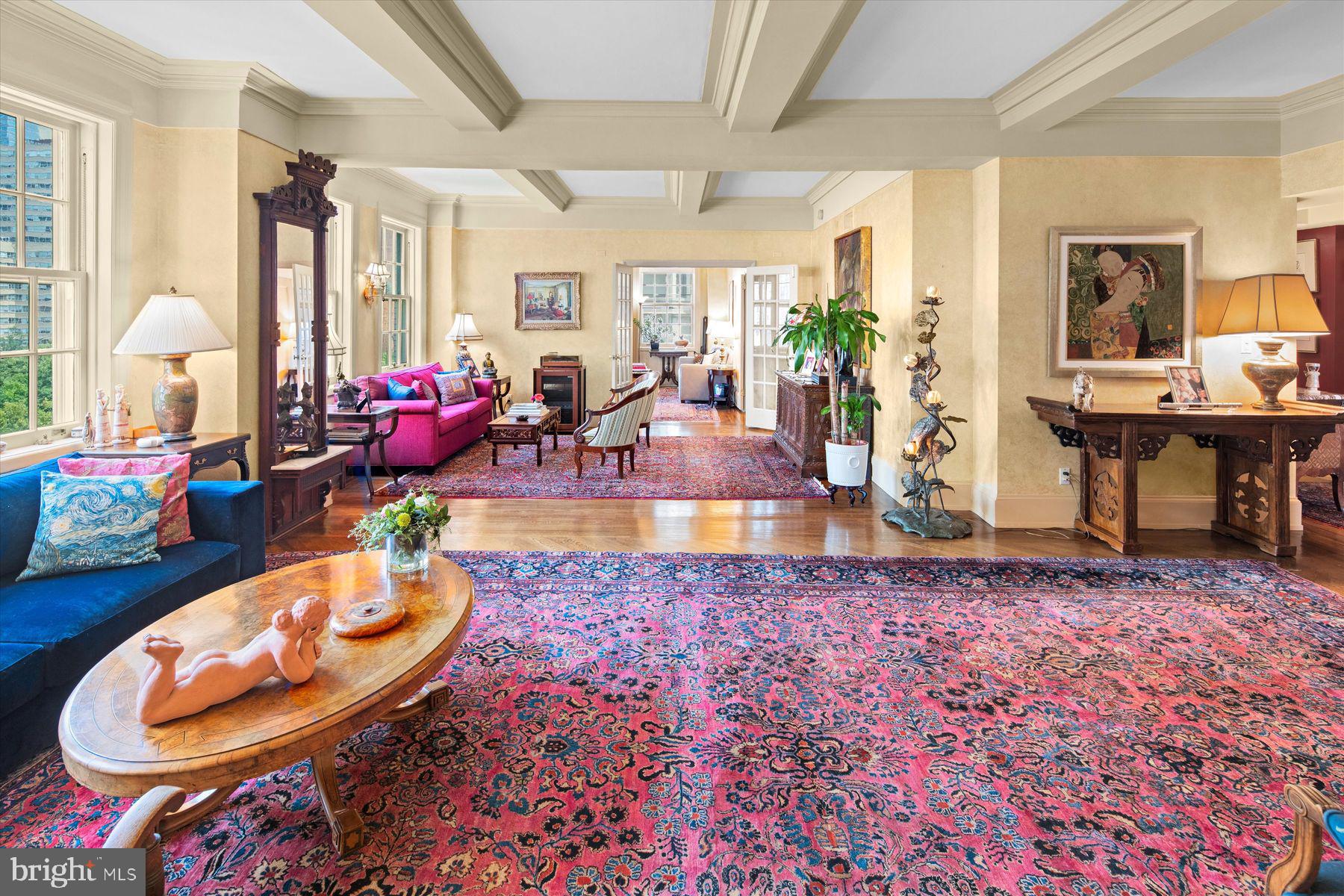 Exquisite and sumptuous Rittenhouse Square Condo. The 10th floor of 1900 Rittenhouse Square is the perfect elevation to enjoy both the treetops of Rittenhouse Square and the architecture of the buildings surrounding the park. Created by joining two units, this residence offers a grand-scale living area, spacious, updated eat-in kitchen, formal dining room plus 3 bedrooms, 2.5 baths and a full-sized laundry. Its herringbone hardwood floors are timeless; there’s wall space for art and substantial millwork for touches of old-world visual interest. The kitchen is outfitted with a wealth of storage, including an attached “Costco Closet.” A Viking six-burner gas range and vents hood will serve the home chef (or caterer!) well. It’s rare to have a city kitchen with this amount of counter space and cabinetry. There is a charming breakfast/casual dining nook in the kitchen complete with window. The dining room is sized to accommodate a crowd and has beautiful millwork and broad 8-over-8 windows. With multiple seating areas and its direct Rittenhouse Square views the living room is perfect for entertaining. The evening cityscape is sure to enchant. Also facing the Square, the sizable 3rd bedroom, presently used as a study offers many costumed built-ins. A hall bath finished in Carrera marble and a linen closet serve the second bedroom.  The romantic main bedroom suite is a true haven and features a deluxe bath with soaking tub, glass-enclosed stall shower, double vanity, plus a walk-in closet. Yet another hall walk-in closet, powder room, laundry and additional basement storage complete this haven on the fully residential south side of the Square. Enjoy this doorman building and easy access to the many restaurants and shops that are a central part of the appeal of an address on the Square and all that Center City has to offer.